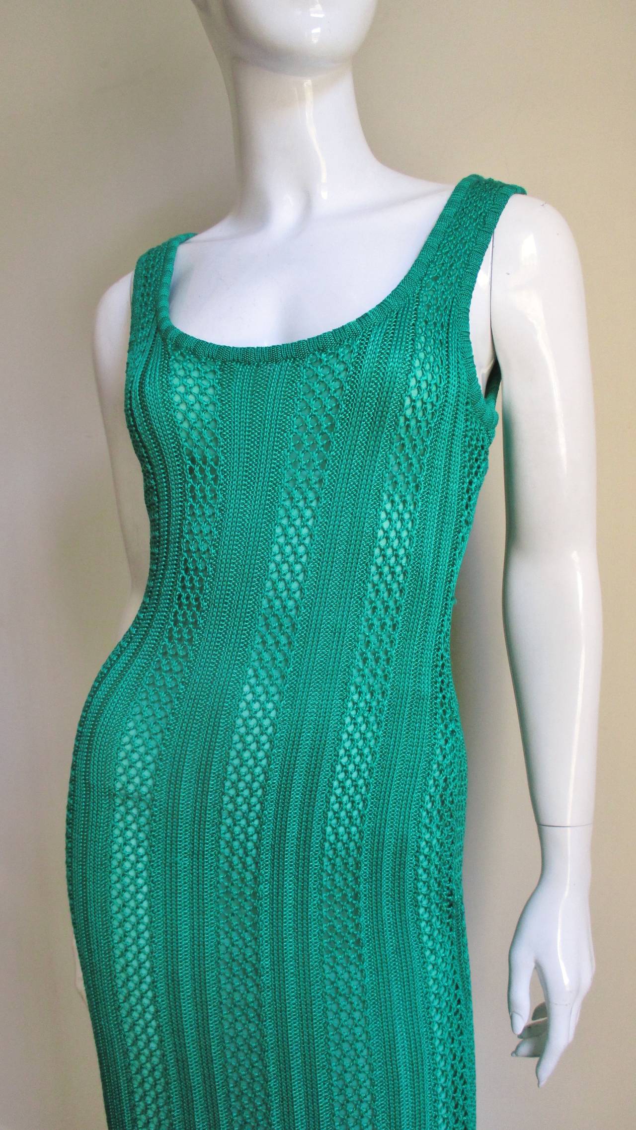 A full length silk knit patterned dress in a beautiful emerald green from Gianni Versace Couture.  A body hugging silhouette with a scoop neck front and back.  It slips on over the head and is fully lined in matching green lining.  
Excellent