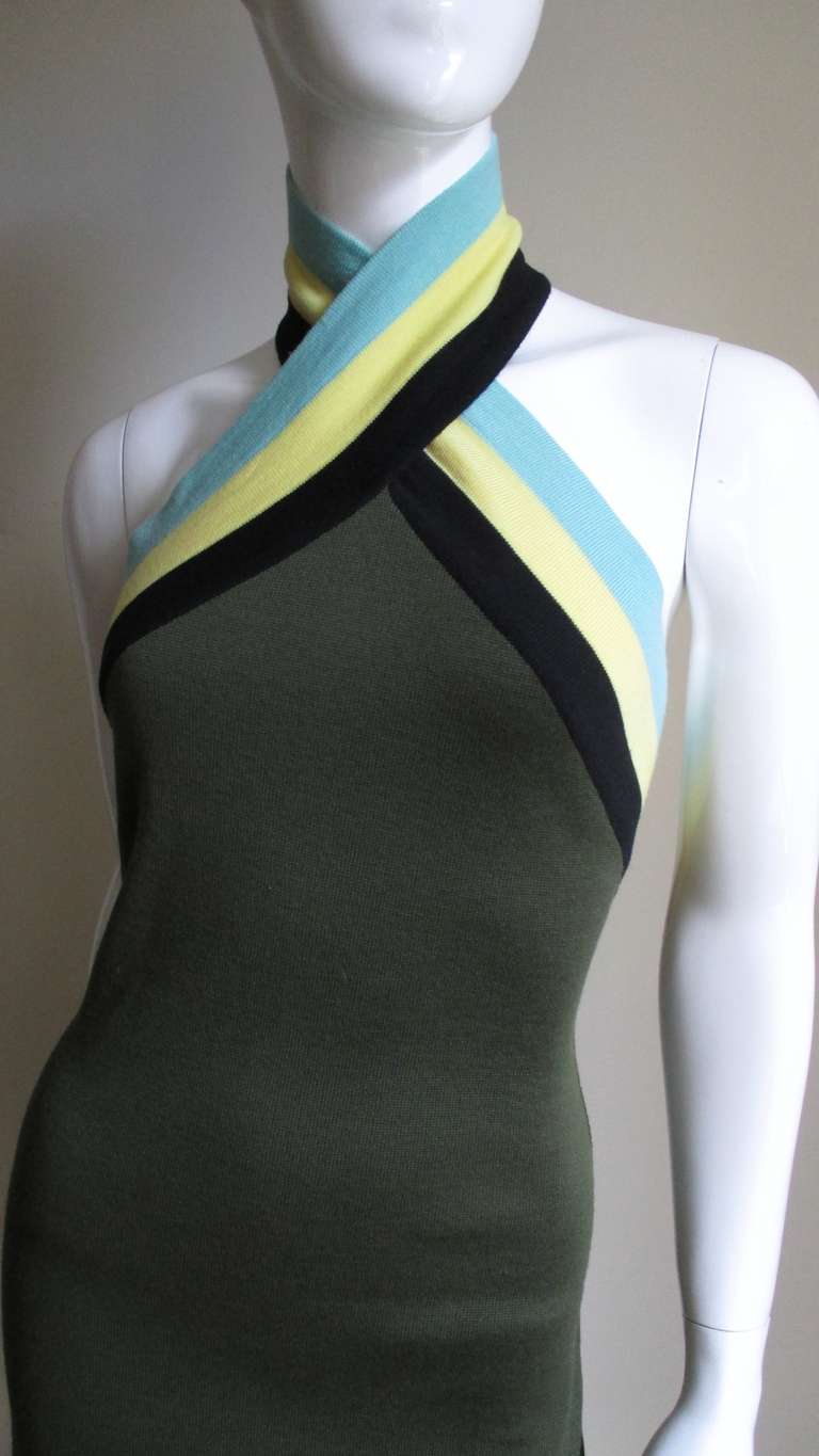 From Gianni Versace Couture a great olive green knit dress with a contrasting striped wrap halter neck in yellow, blue and black.  Made of a soft lightweight wool it gently falls along the lines of the body.  The halter crosses wrapping around the