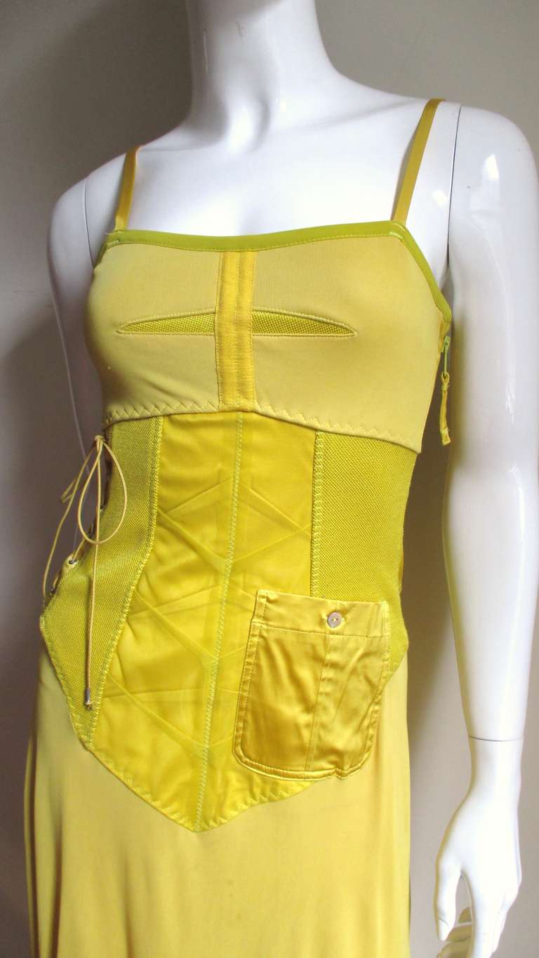 An amazing dress from Jean Paul Gaultier in shades of yellow (plus a little lime) silk, rayon and spandex.  This dress has all the bells and whistles, bodice lacing on one side, decorative zipper on the other, a  button patch pocket, front panel