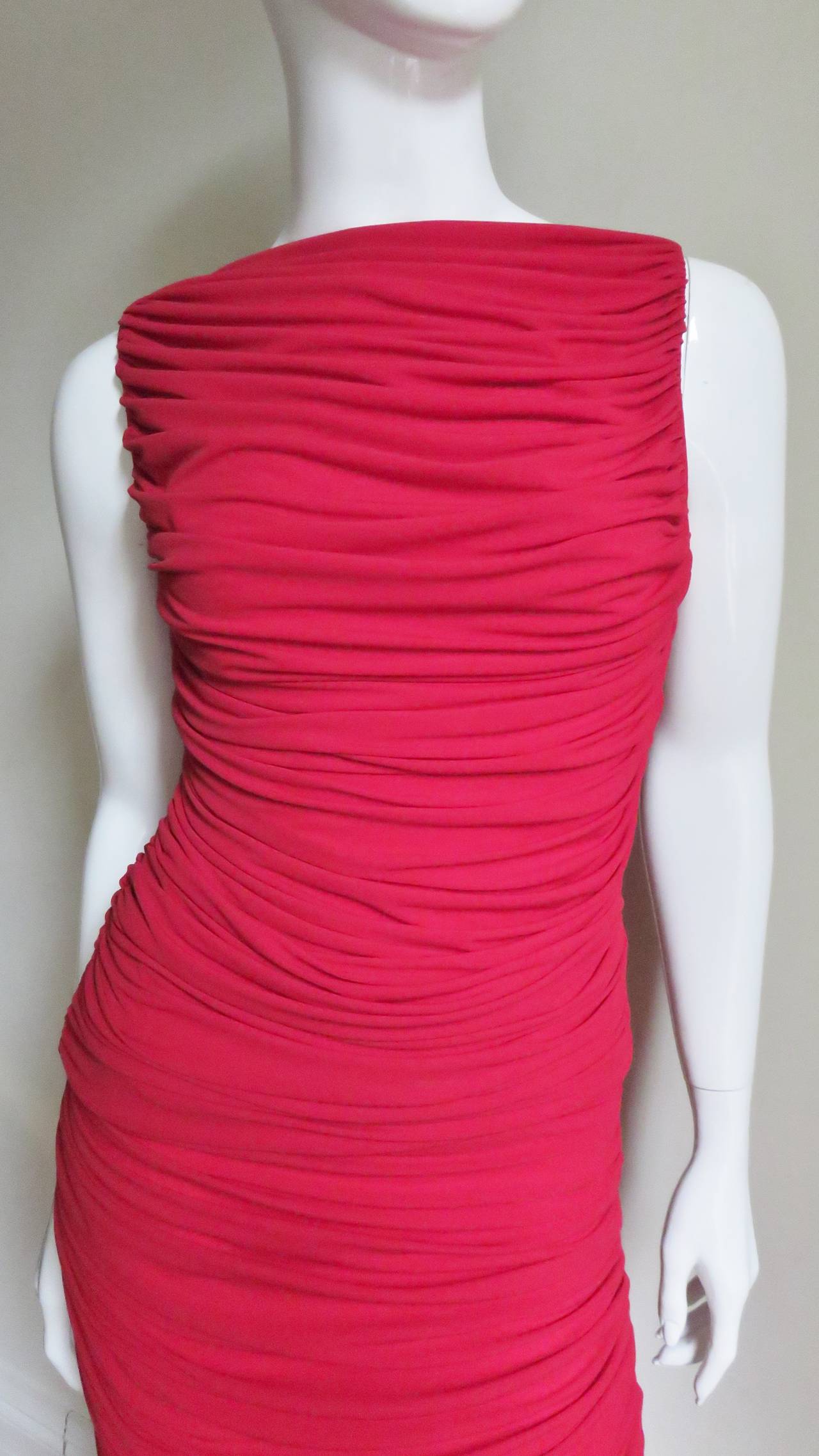 A great set in red silk jersey skirt and top from Norma Kamali.  Both pieces are ruched at the sides with the fabric draping across the front and back creating folds.  The top is sleeveless with a bateau neckline and the skirt is straight cut to