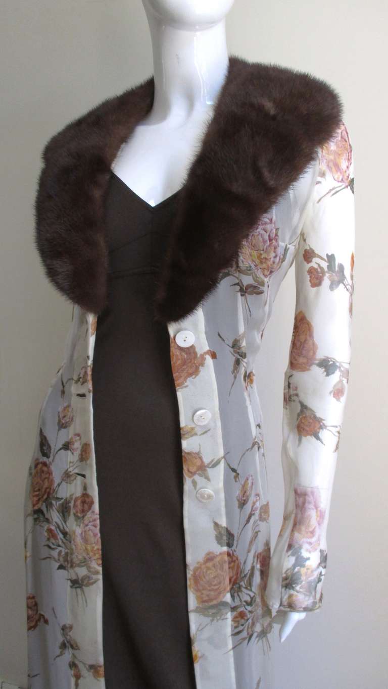 A fabulous full length 2 piece set from Dolce & Gabbana consisting of a slip style brown knit dress and a sheer flower pattern coat in off-white with  peach flowers with a touch of brown and green leaves topped off with a fabulous, luxurious mink