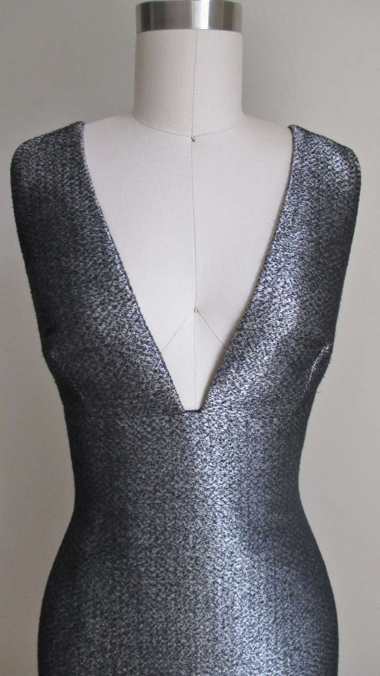 A great fitted dress in a grey, silver, black woven silk wool combo giving it a soft, shiny effect.  It had a plunge neck front and back, even the armholes are cut to same shape and level.  It is fitted through the body then straight to the hemline.
