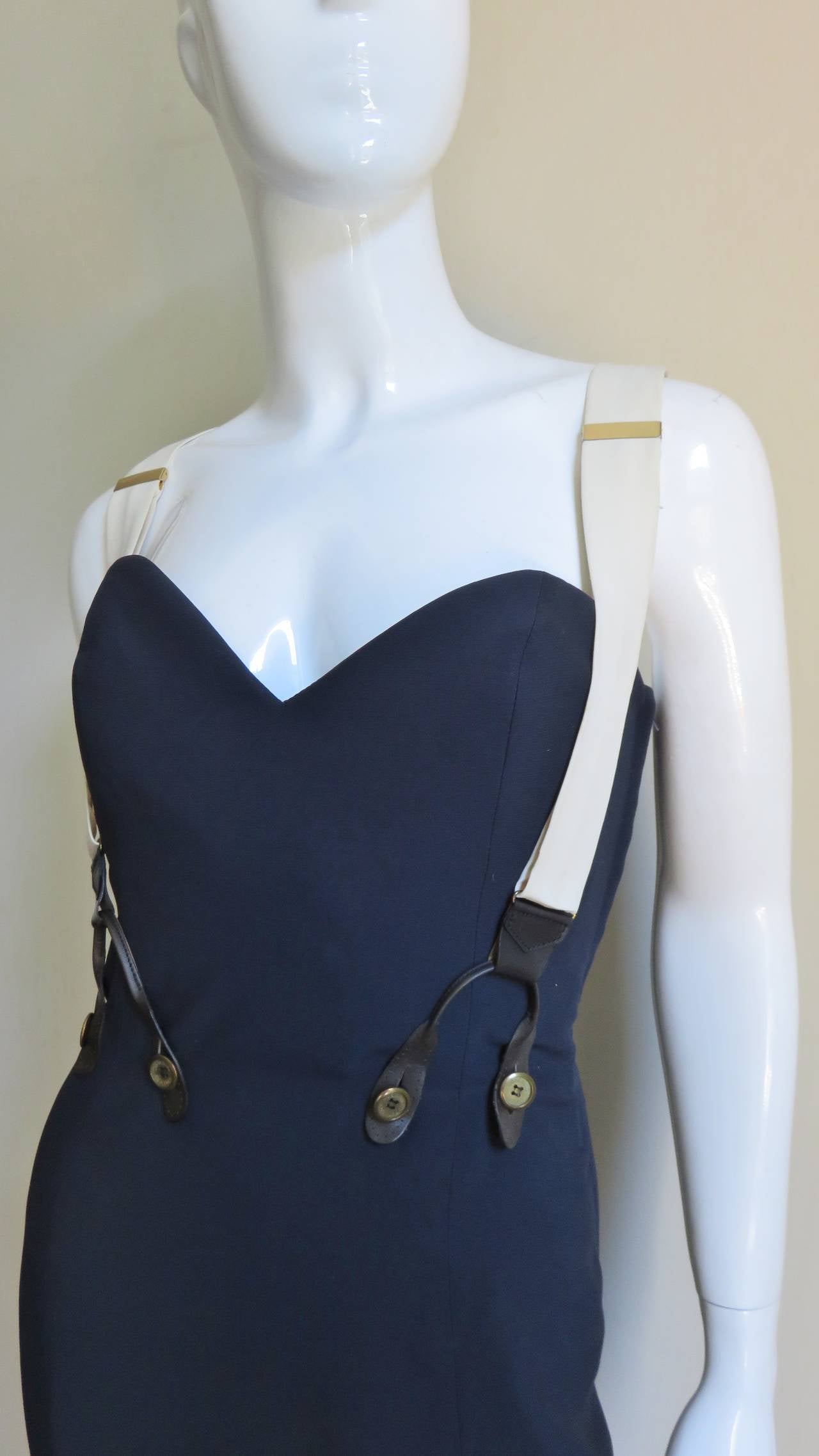 A fabulous dress and jacket set from Moschino Couture in navy and off white.  The fitted boned bustier dress comes with adjustable, detachable suspenders which button onto the waist front and back.  A boxy open off white jacket with faux flap