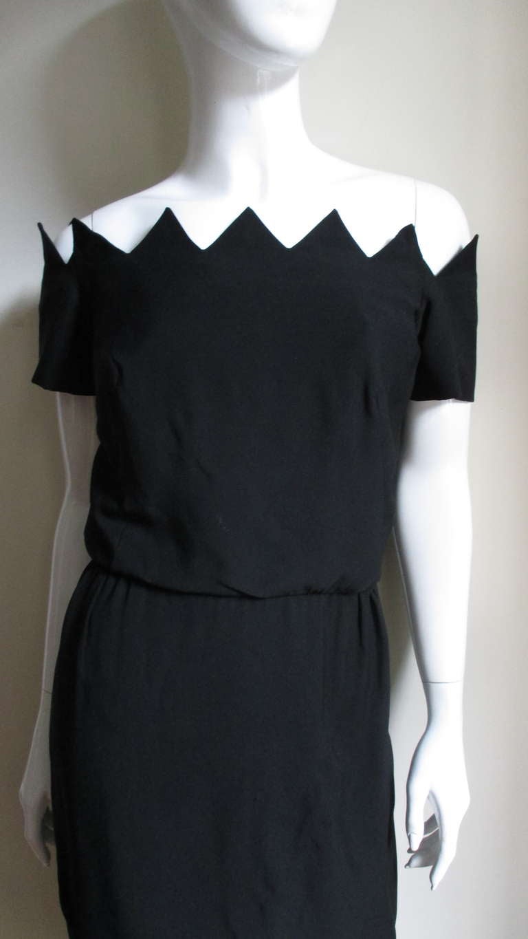 A great 1950's black silk wiggle dress from Howard Greer.  Off the shoulder, slight blouson bodice and a fitted skirt.  Fabulously detailed in points along the neckline and hem.  There is an inner boned corset and hidden straps to hold the sleeves