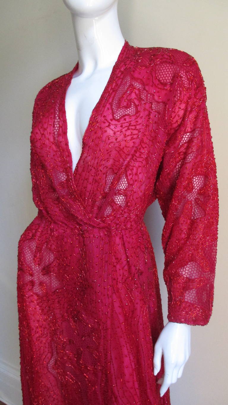 Such an amazing detailed elegant red silk dress from Halston wrap dress.  The dress is covered in red glass tubular beads and intricate fagoting netting in flowers and abstract shapes pattern.  The dress has a plunge neckline, slight dolman sleeves