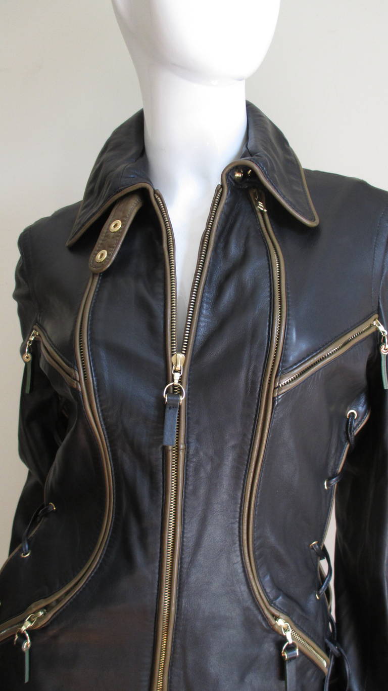 A fabulous soft supple black leather jacket with brown trim from Gianfranco Ferre.  His archetctual talents translate into the great lines of this jacket.  It has a shirt collar, curved front zipper seaming, four symmetrically placed front pockets