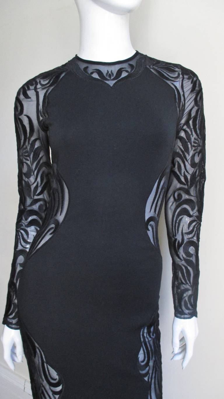 An incredible black knit dress by Versace.  It has an hourglass panel in the front and back joined by side panels of lace from top to bottom including the sleeves.  It is unlined and has a back zipper.
Excellent new with tags unworn condition.  Fits