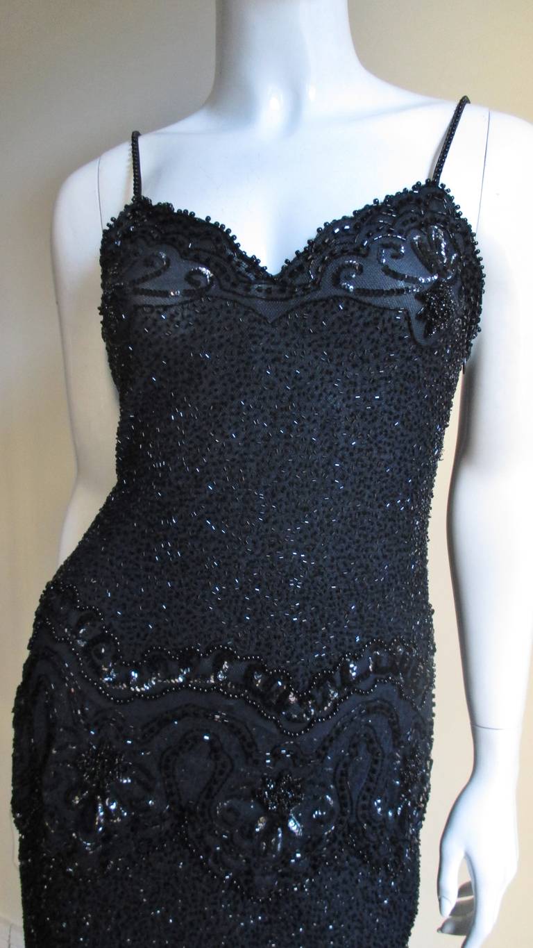 A gorgeous 2 piece set from Fabrice Couture in black semi sheer silk mesh covered in glass beads and sequins over silk from Fabrice's Couture line. The camisole style top has spaghetti straps and a scallop edge at the hem.  The straps and the top