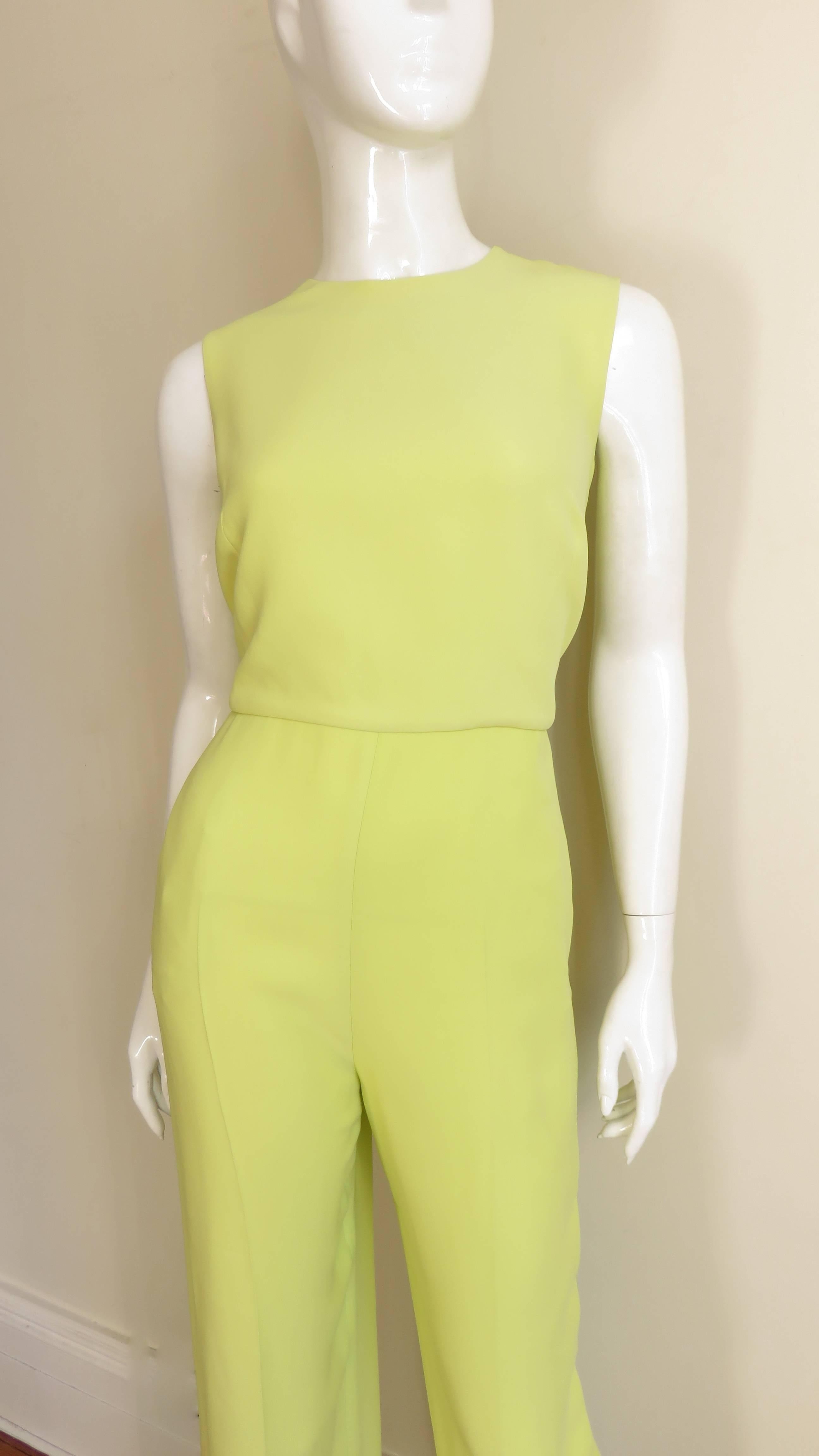 A great bright lemon with a touch of lime silk/wool blend sleeveless jumpsuit from Valentino.  Simple eglegance from the font with a crew neck, straight legs and fitted seam the waist.  The back has that something extra with a side seam to side seam