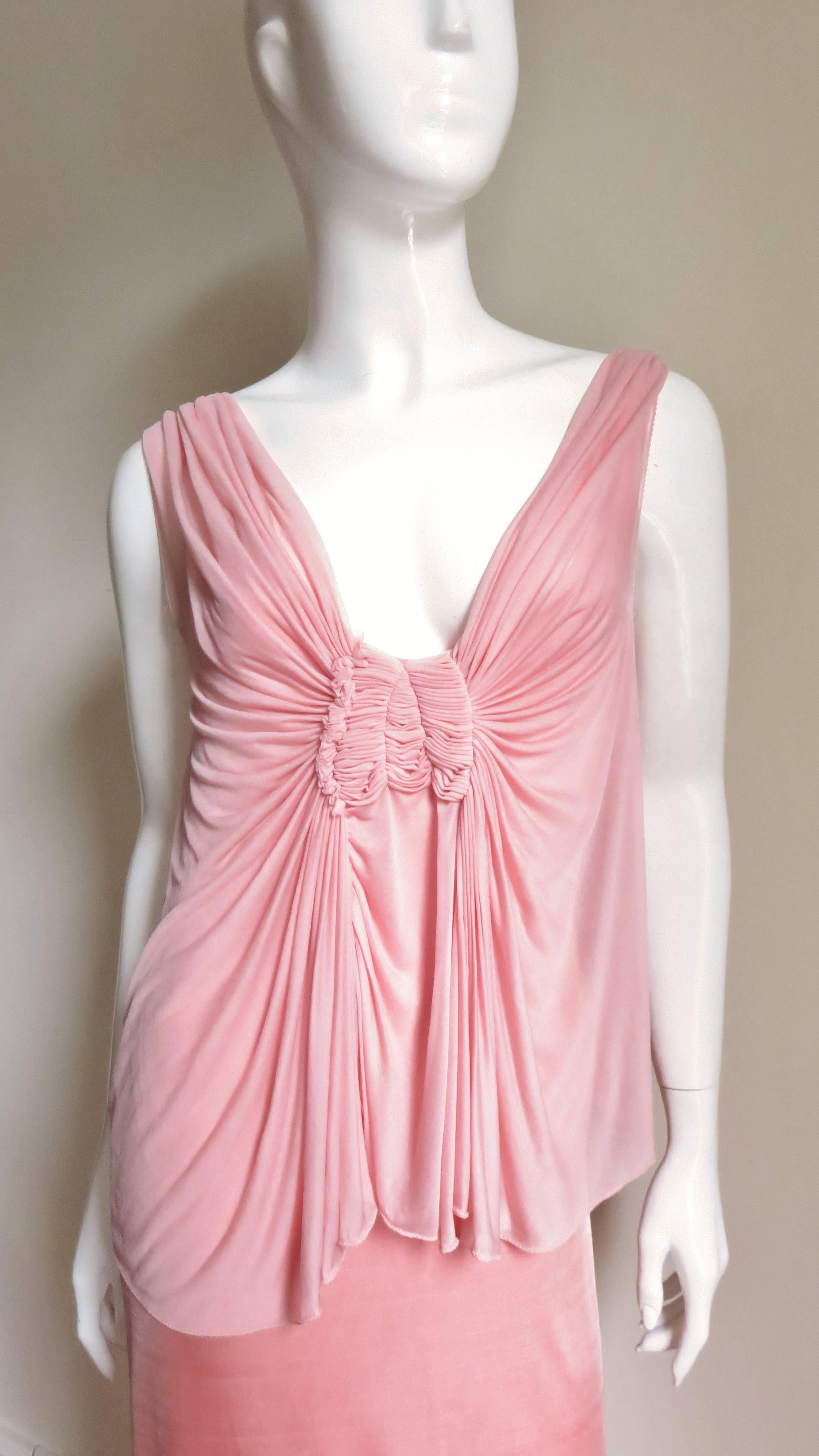 A beautiful fine silk jersey in a lovely shade of pink.  It has a plunging neckline front and back with sheer ethereal draping at the back shoulders.  The ruched front bodice all gathers into an elaborate ruched panel at the base of the neckline. It