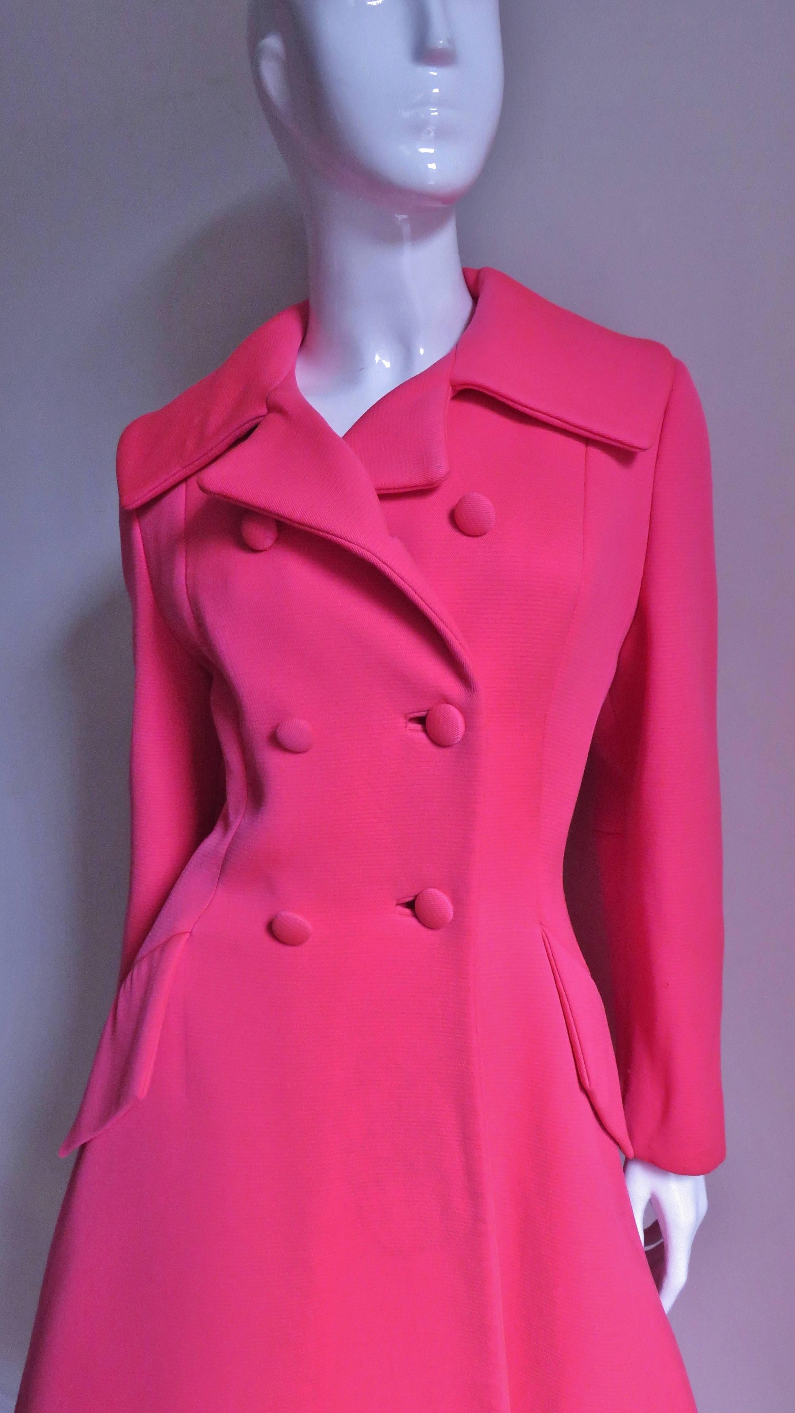 Made of shocking pink wool/silk twill this magenta pink 1950's Lilli Ann coat makes quite a statement. So stunning in it's brilliant pink color and flattering hour glass shape.  It is double breasted with self covered buttons and bound button holes