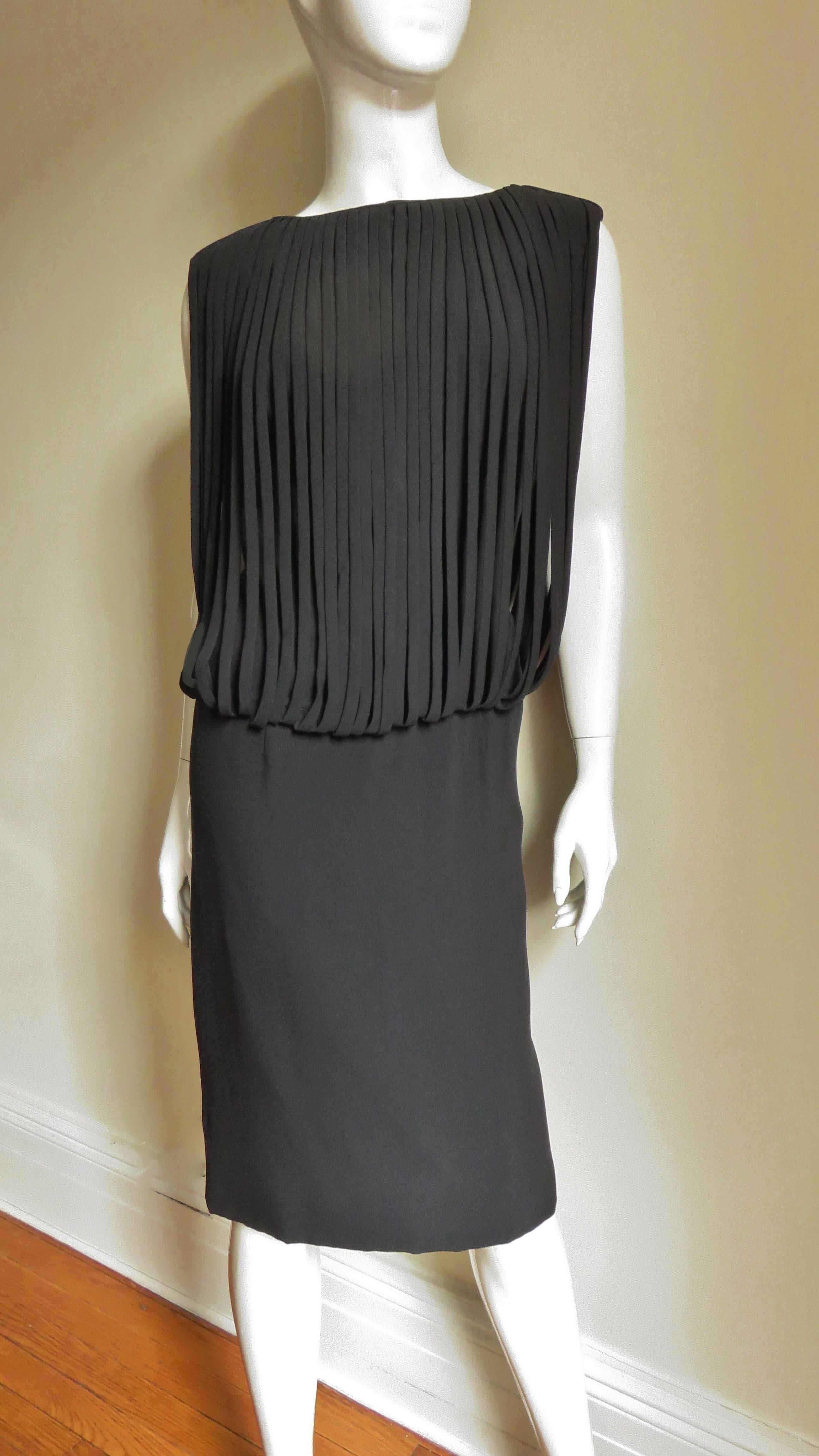 A fabulous little black dress from Oleg Cassini.  A semi fitted dress with an over bodice comprised of dozens of 1/3