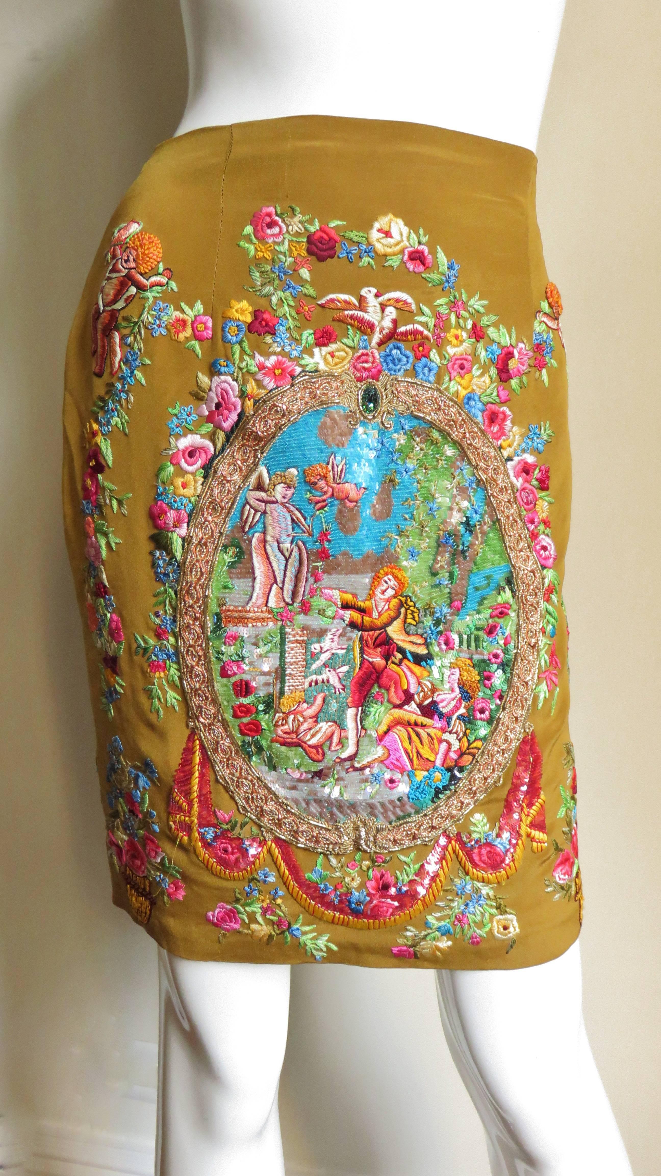 This is absolutely stunning!  A tan silk skirt completely embroidered in silk thread vibrantly colored, intricately detailed Renaissance figures, animals, birds, angels, flowers. from Todd Oldham.  There is a large oval embroidered panel in the