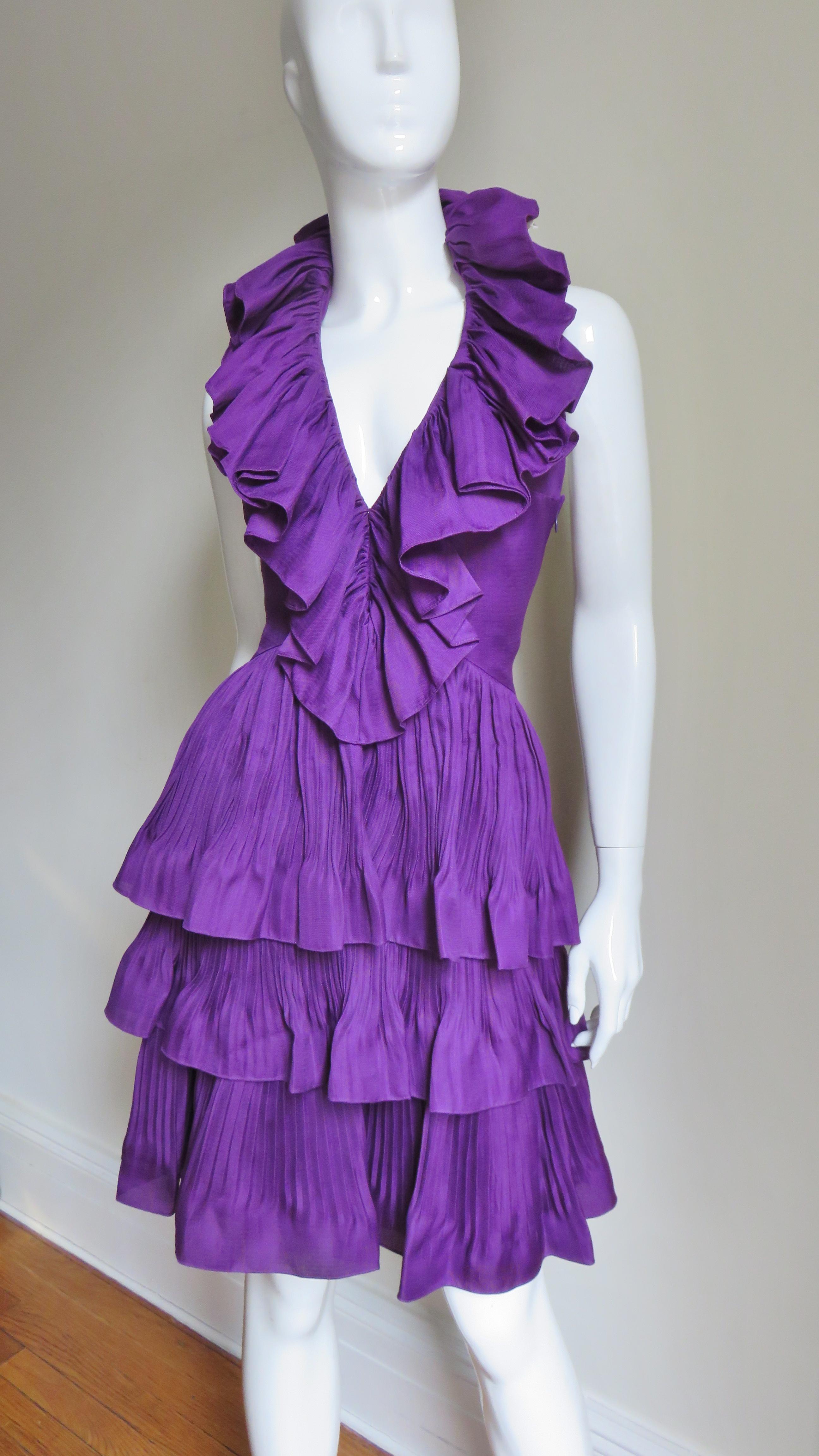 A gorgeous rich purple silk halter dress by John Galliano for Christian Dior.  It is fitted through the bodice with a stunning intricately detailed ruffle trimmed plunge halter neckline (great pains have been taken in the construction of the ruffle