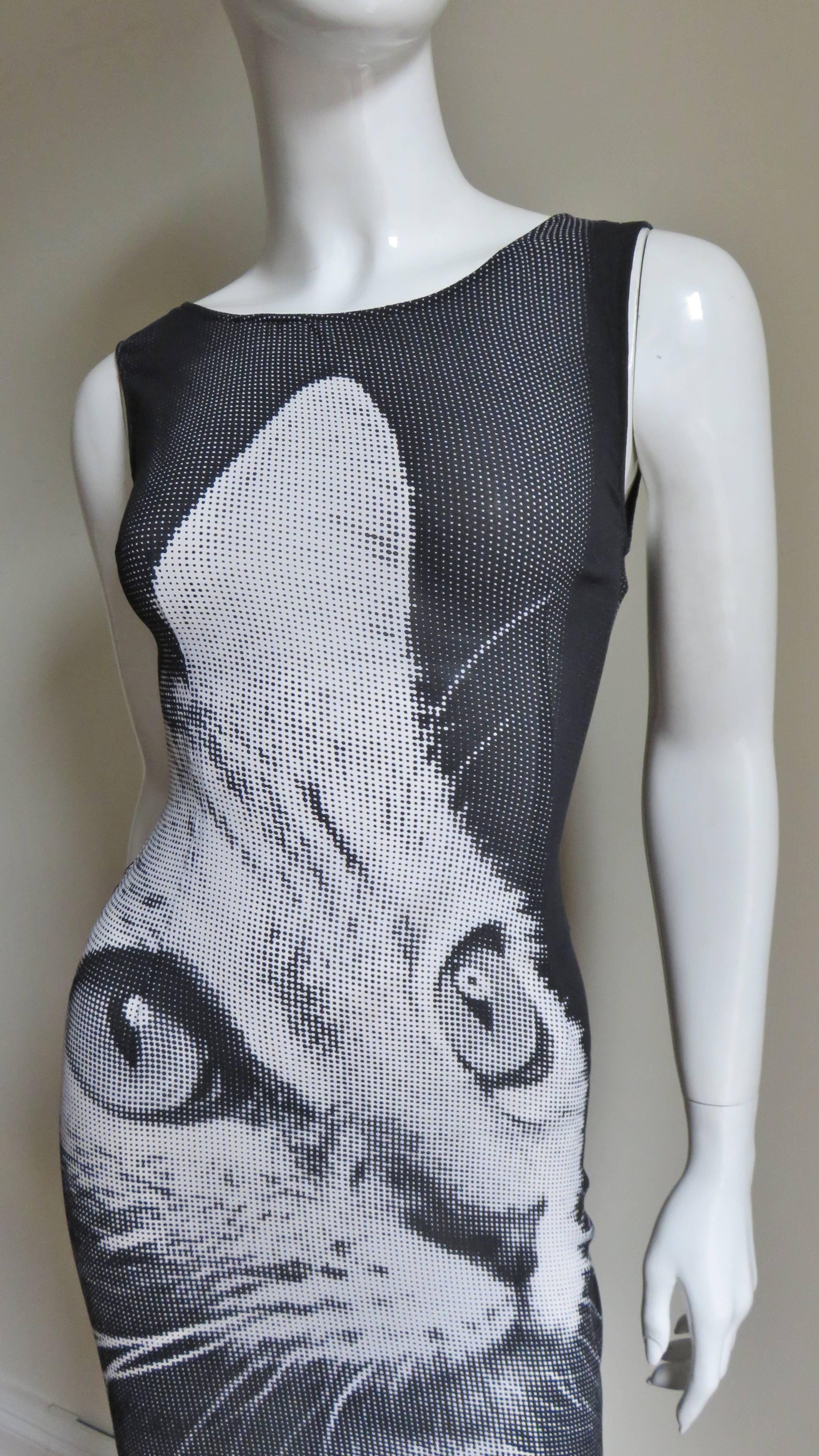 A fabulous light weight stretch silk dress in greys, black and white with a pixelated cat image on the front.  It is a sleeveless fitted dress with a rounded neckline and a V back.  I has a center back zipper and is unlined.
Excellent condition. 