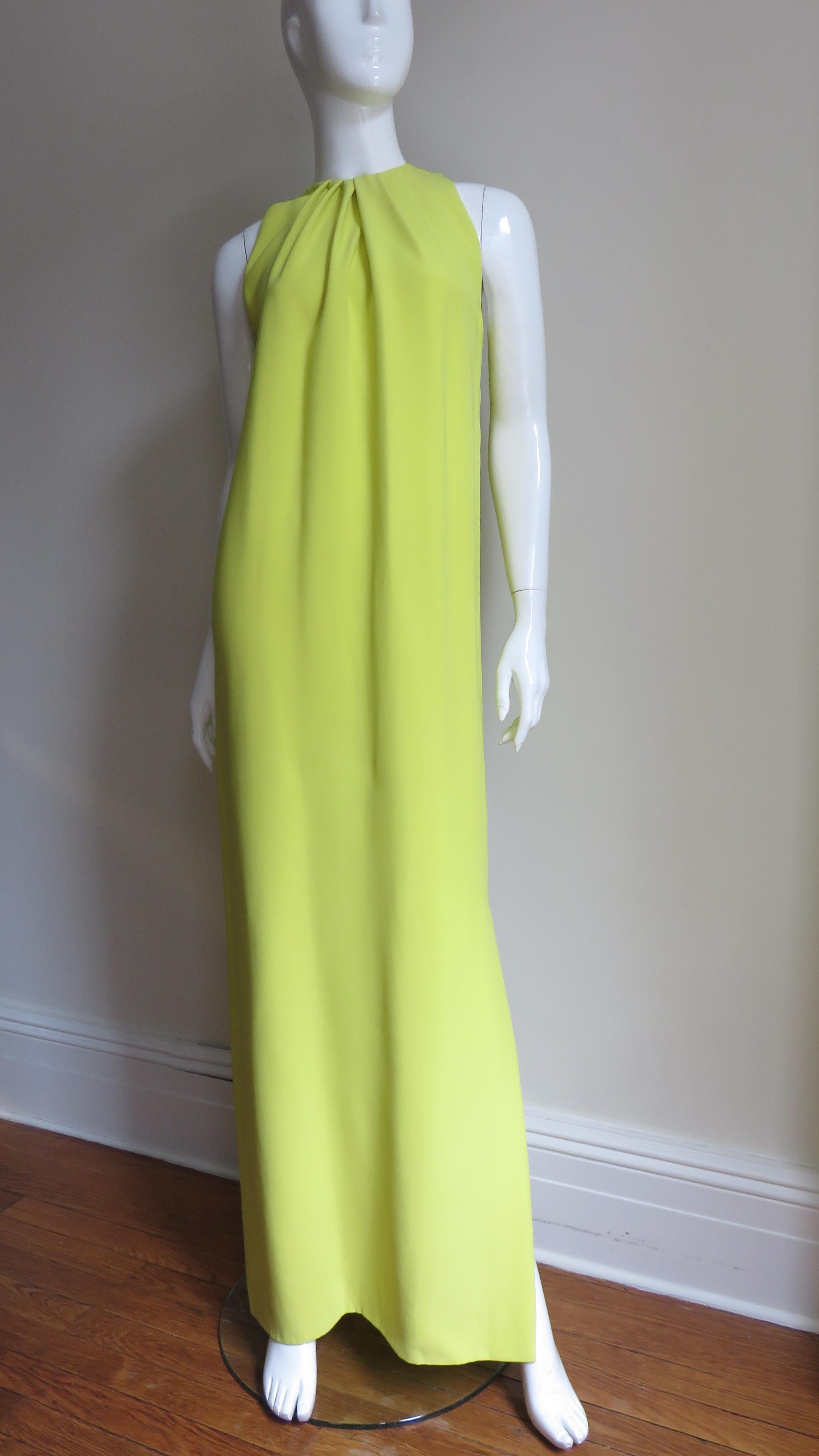A beautiful bright citron silk gown from Christian Dior.  It has a crew neckline with inverted tucks around it's circumference opening to create fullness- simple and elegant.  It is lined in citron silk and has a matching invisible back zipper. 
New