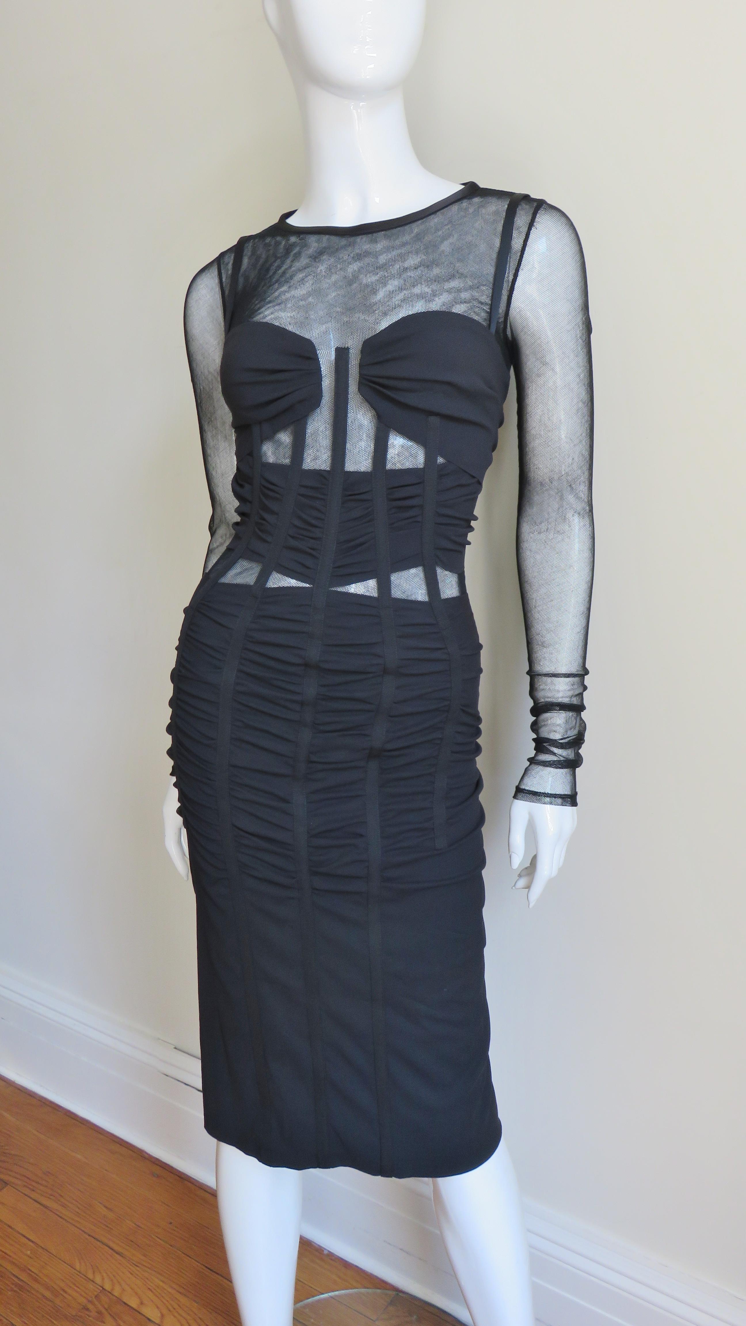 A fabulous sheer and silk jersey dress from Dolce & Gabbana.  A fitted long sleeve dress with ruched silk jersey over the mesh at the bust (which includes adjustable bra straps) and waist with mesh peeking out above and below it.  The bodice is