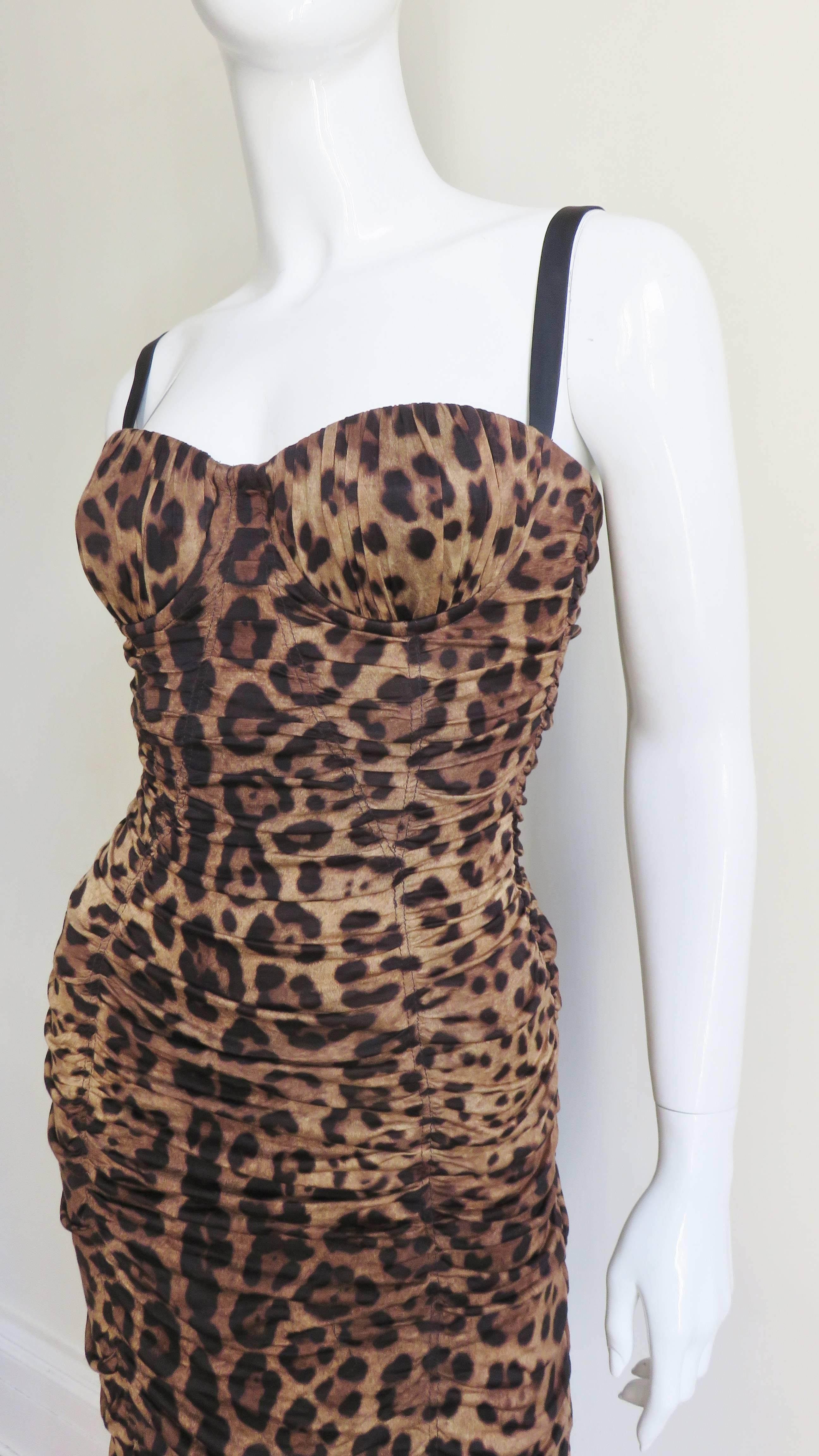 A fabulous fine silk with stretch leopard print wiggle dress from Dolce & Gabbana.  It has underwire bust cups, bodice boning and black silk straps.  The dress is fitted with 7 vertical panels horizontally ruched around the dress.  The bodice is