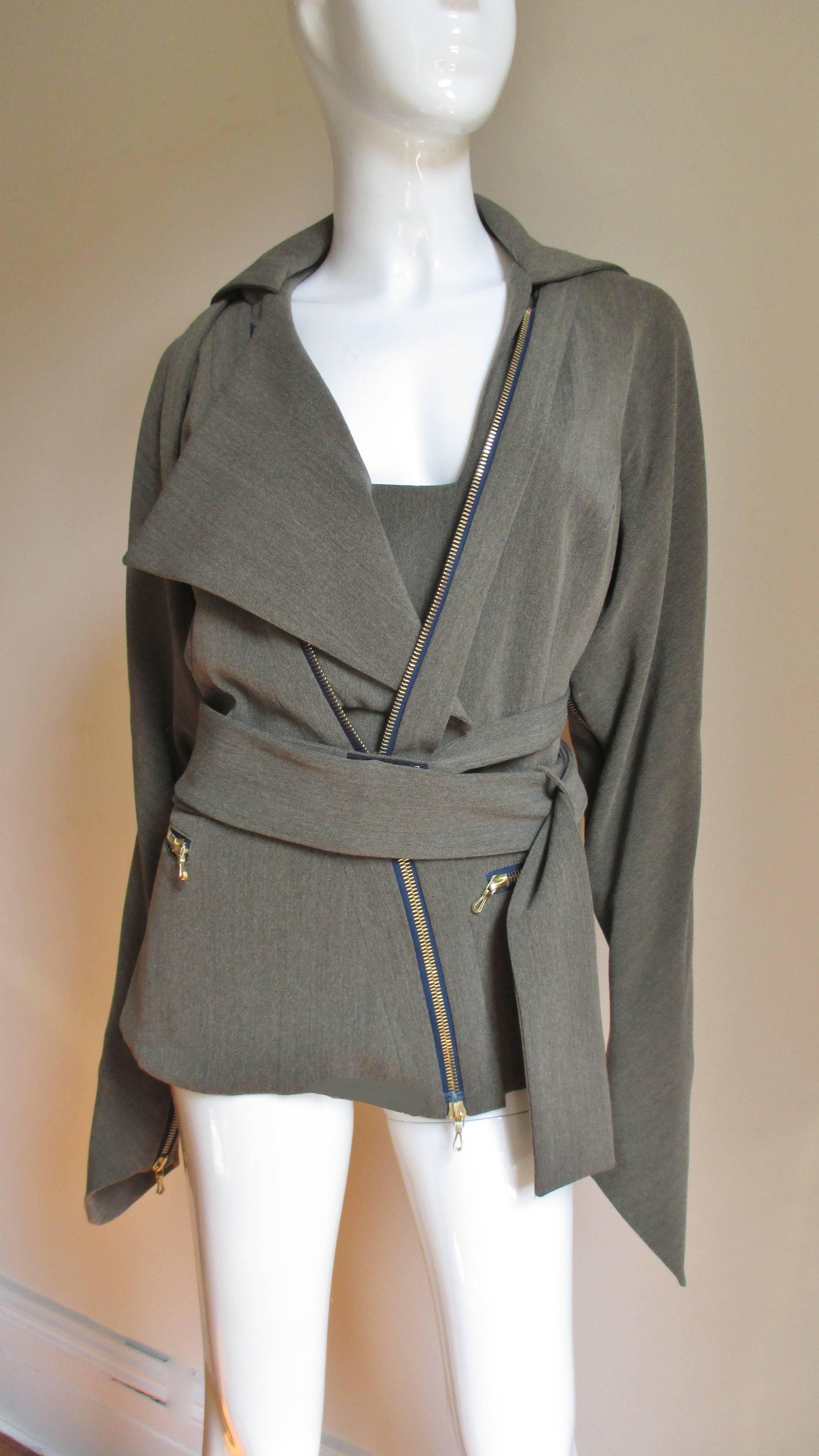 Fabulous bondage style jacket from Vivienne Westwood's couture gold label line in olive wool with a large front zipper.  Multiple straps from the shoulders on the front and back can be worn in numerous ways plus the long pointed sleeves unzip