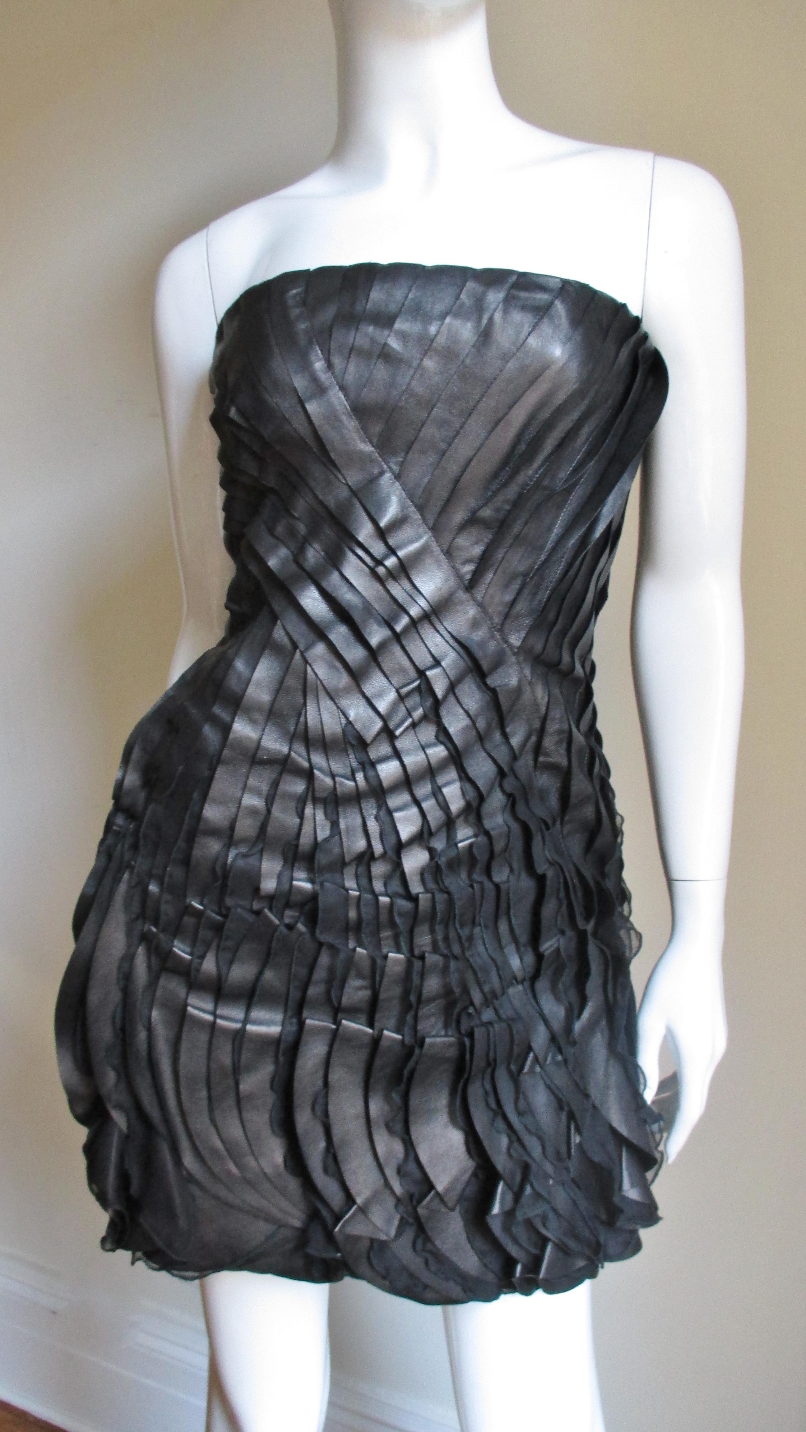 This is a gorgeous leather and silk dress from Valentino.  It is strapless with alternating curved strips of overlapping leather with strips of silk chiffon peaking out each attached along one side crossing at the waist then widening towards the