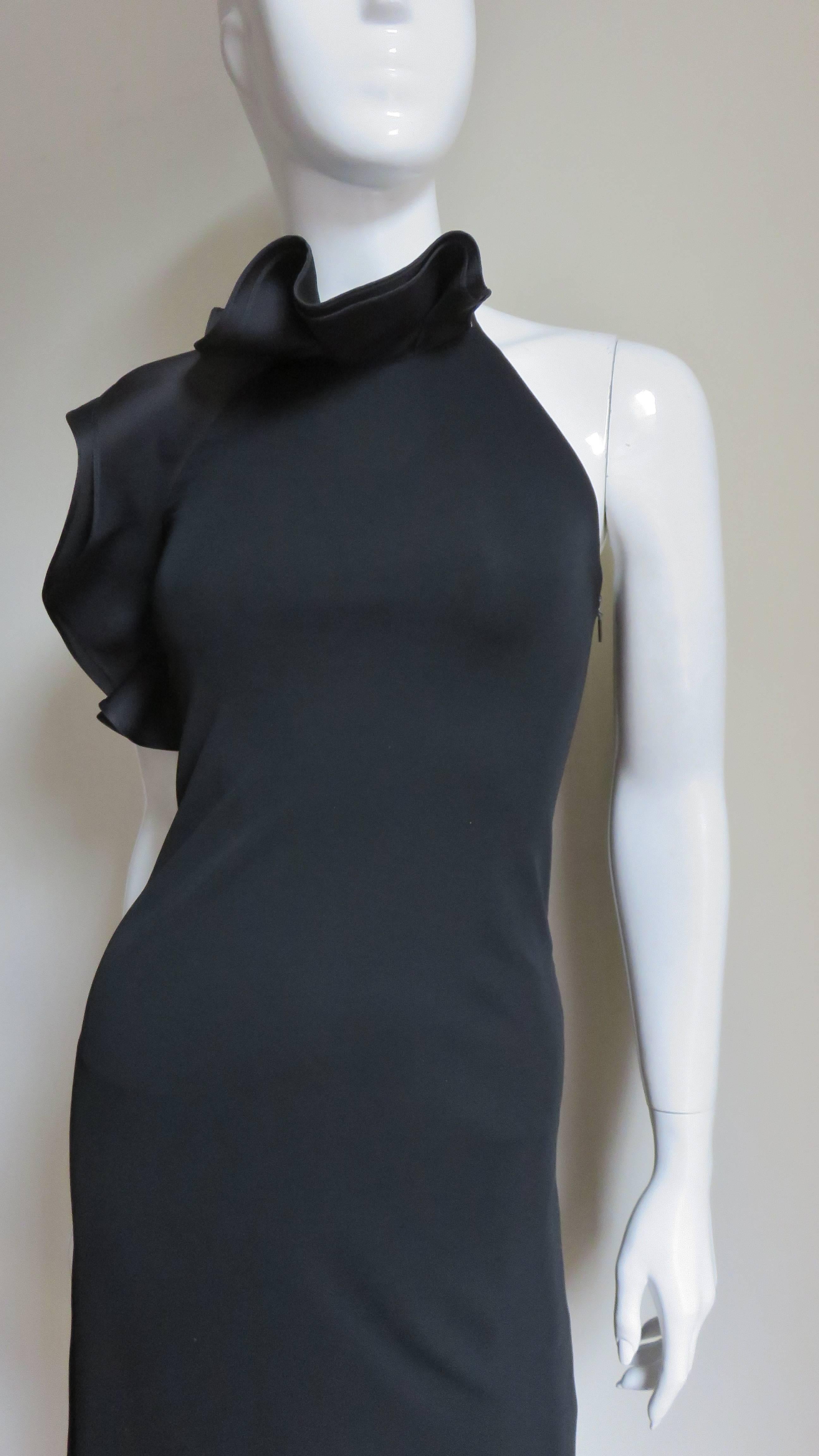 A beautiful black silk jersey halter dress by Gucci.  It is a simple body skimming mini dress with a  fabulous silk organza ruffle stand up collar in the front across the neck down the side to above the waist.  A strap closes at the back neck with a