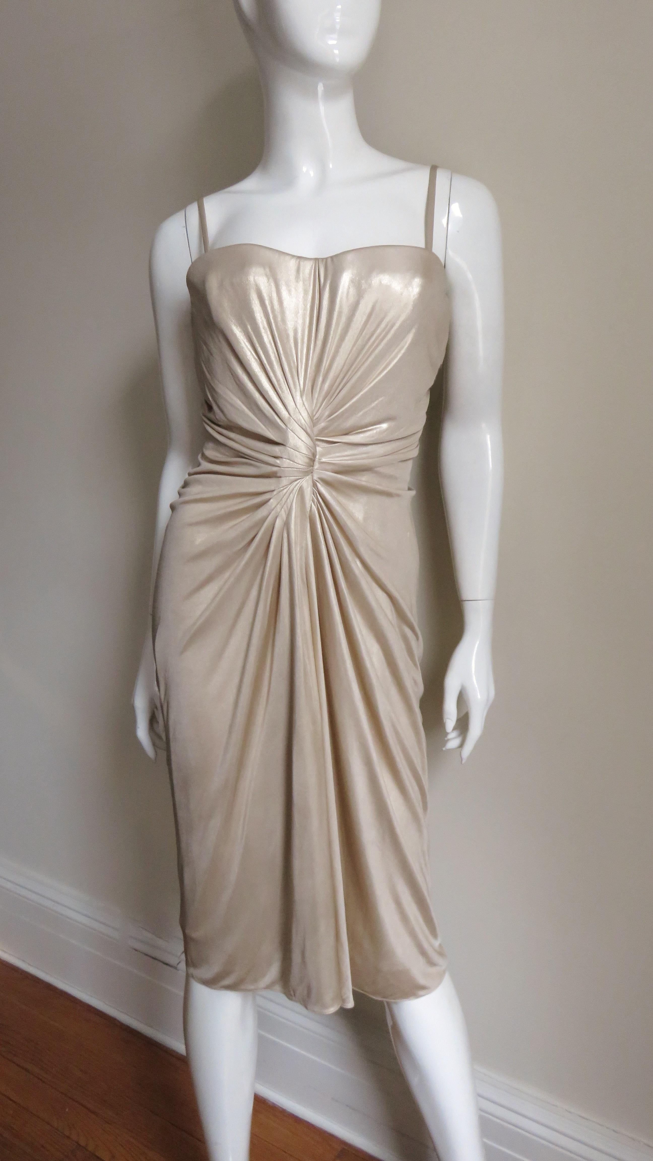 A gorgeous soft gold fine silk knit dress from Christian Dior. It has an inner boned corset with underwire bust cups, and detachable spaghetti straps enabling the dress to also be worn strapless. Very flattering with an array of seaming and ruching