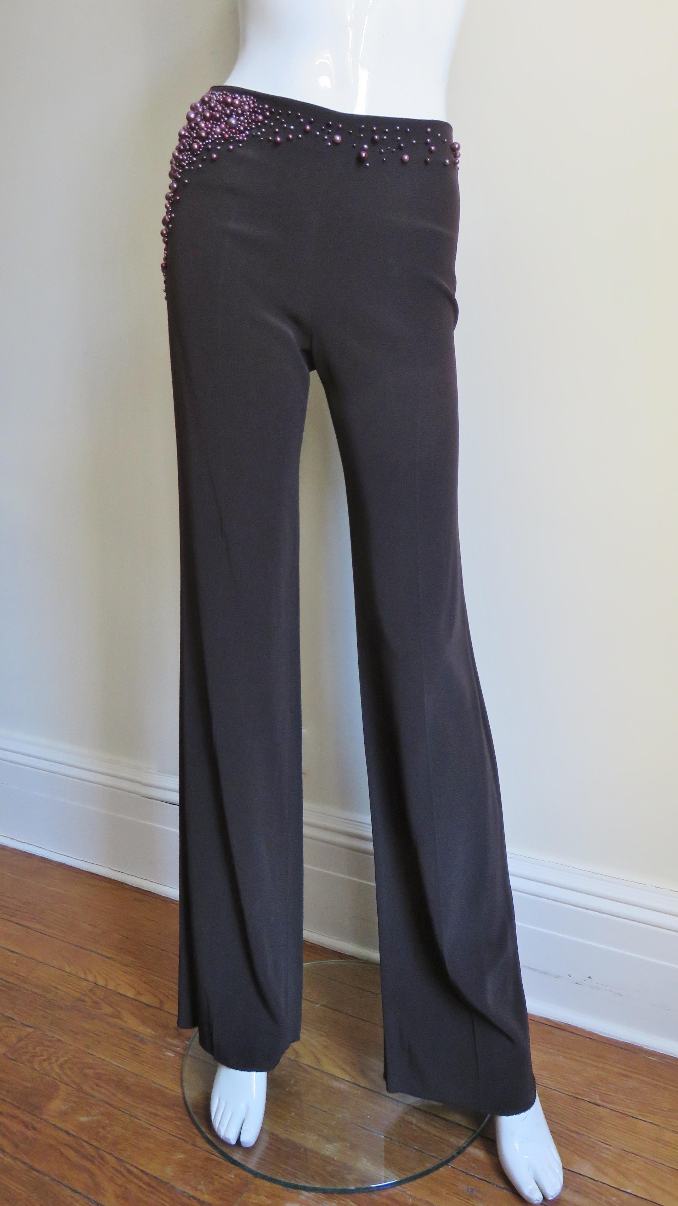 Gorgeous chocolate brown silk pants with stretch from Chloe. They are mid rise, embellished  around the waist and along one hip with pink pearls of varying sizes. Stunning. The pant's legs flare gently to the hem and there is a side zipper.
They