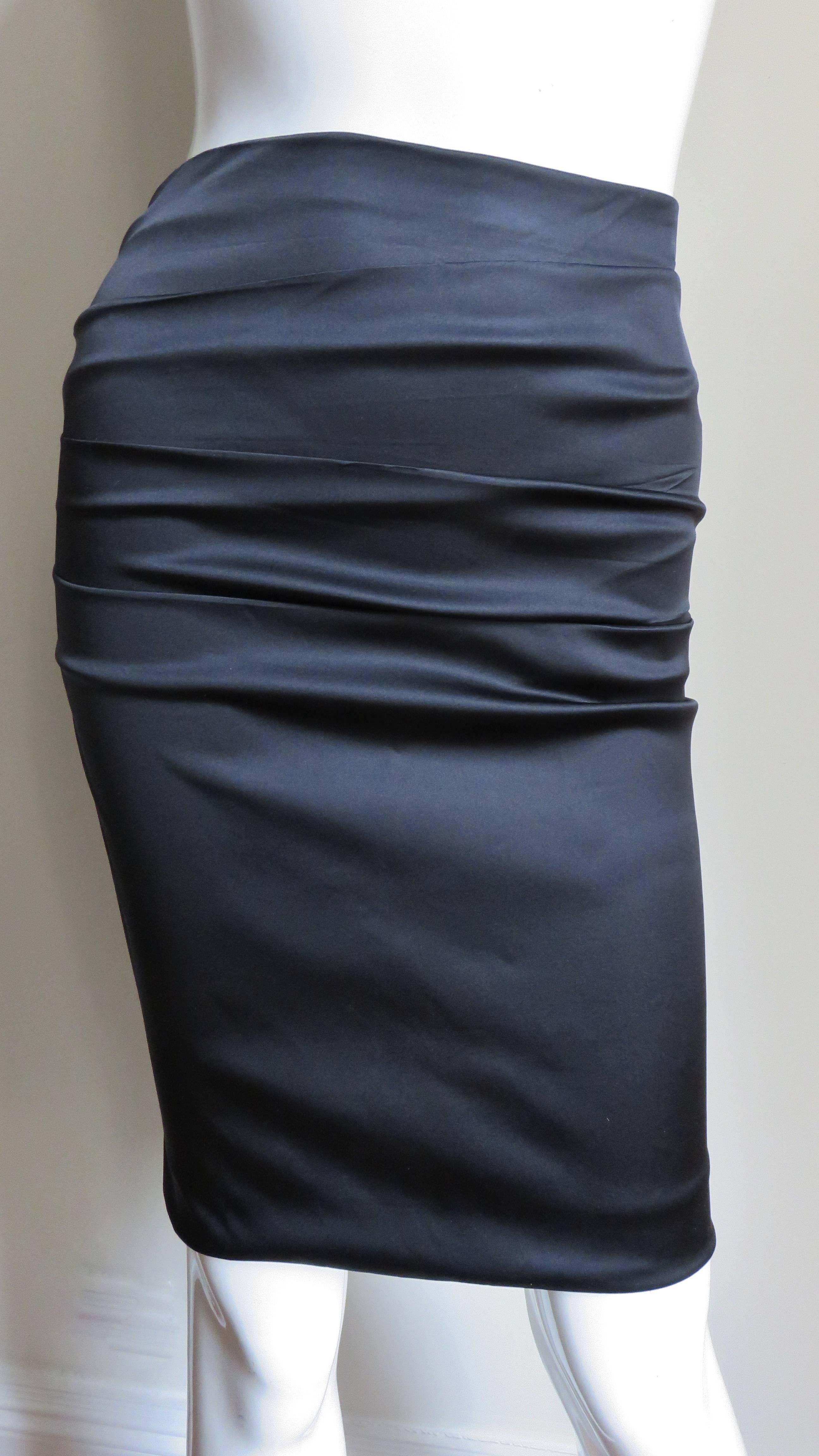 A gorgeous black stretch silk skirt from Dolce & Gabbana.  It is a pencil style skirt with horizontal ruching across the front and back. There is lacing at the center back the length of the skirt.  It has a matching invisible zipper and it is lined