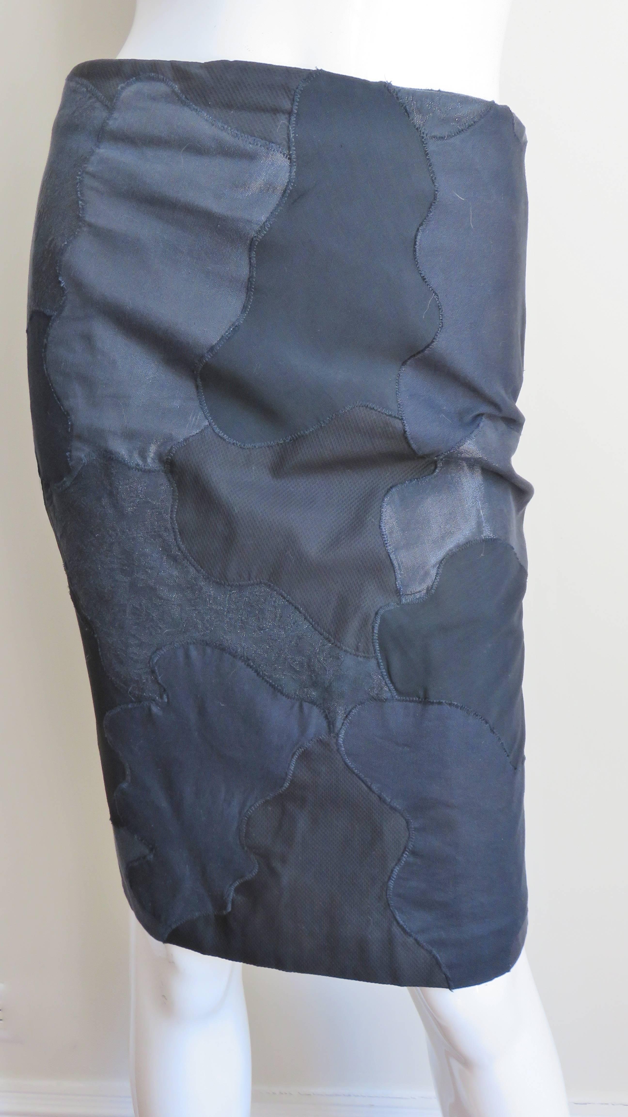 A fabulous black silk and cotton skirt in a patchwork in varying shapes from Alexander McQueen. It is pencil style with a back kick pleat, back zipper and it is lined in black silk.  
Appears unworn.  Fits size Small, Medium. Marked US size