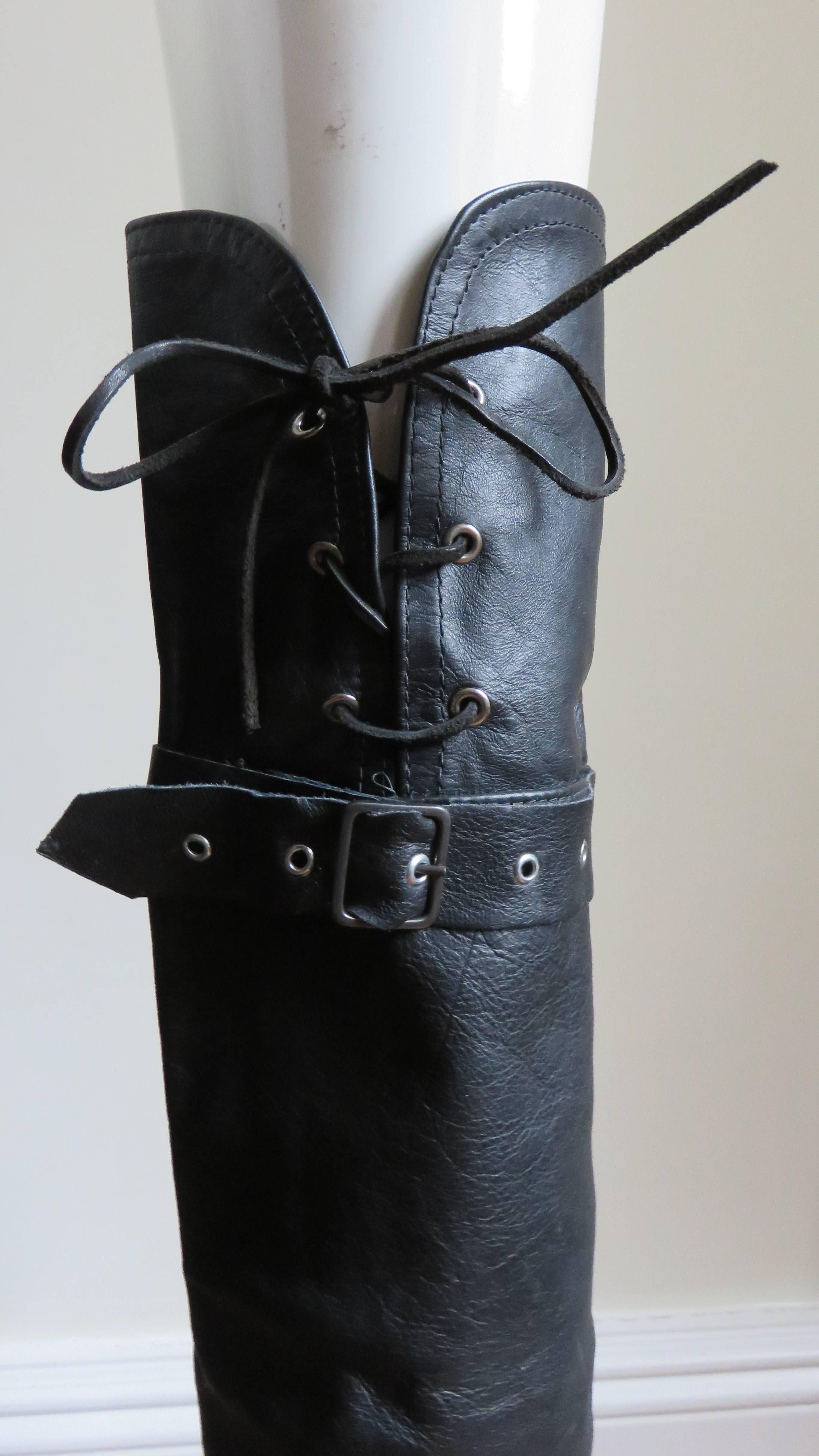 A fabulous pair of black leather leg warmers.  They have functional belts fitting through tabs around above and below the knees.  The tops are curved in the center back with 6" of functional lacing.  The ankles have bands and rings.
Excellent