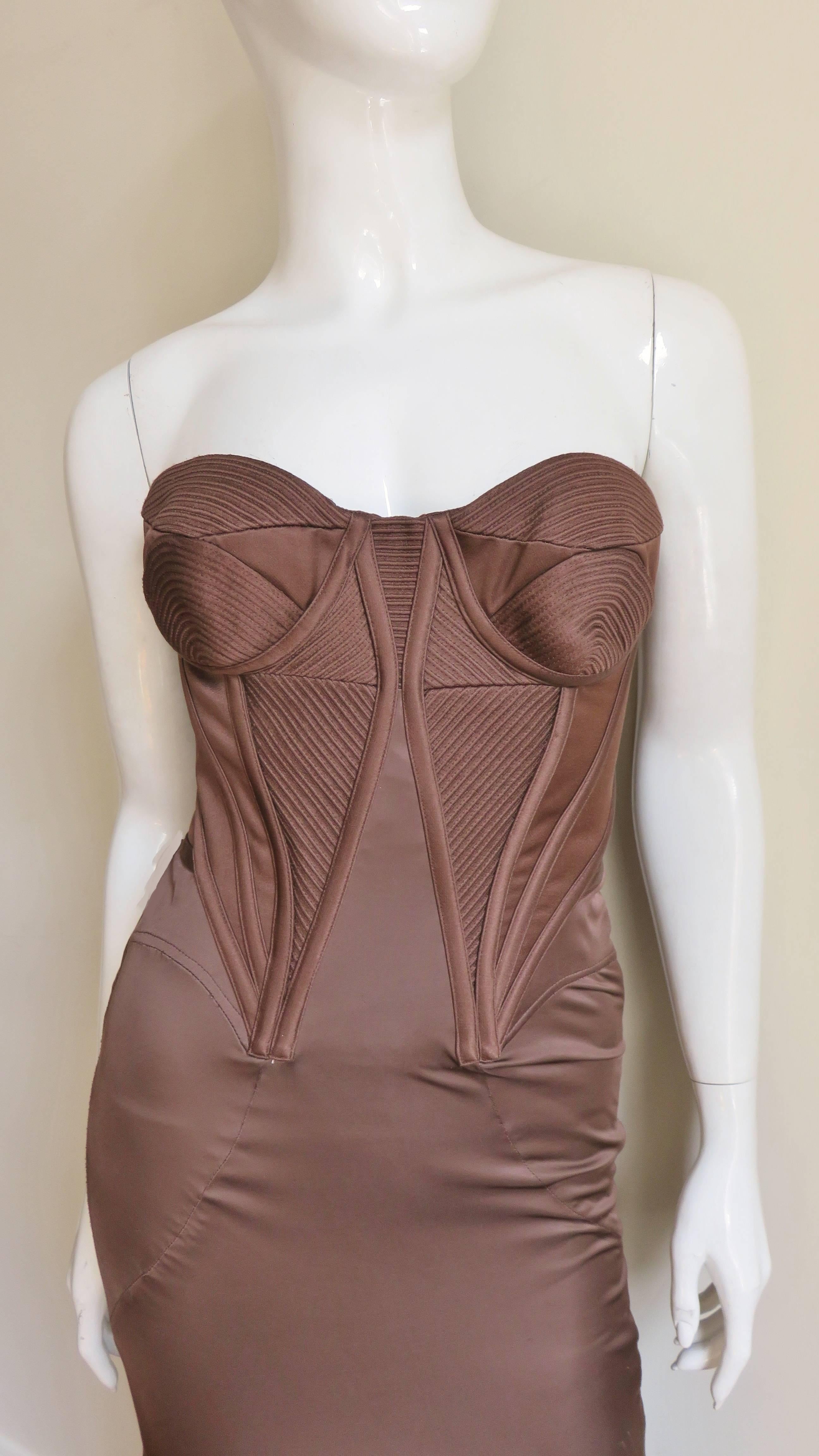 This is a stunning rich chocolate brown silk gown from Versace.  The strapless bodice has formed detailed cups, boning at angles and intricate stitching patterns throughout both front and back all contributing to a fabulous fit and cinched waist. 