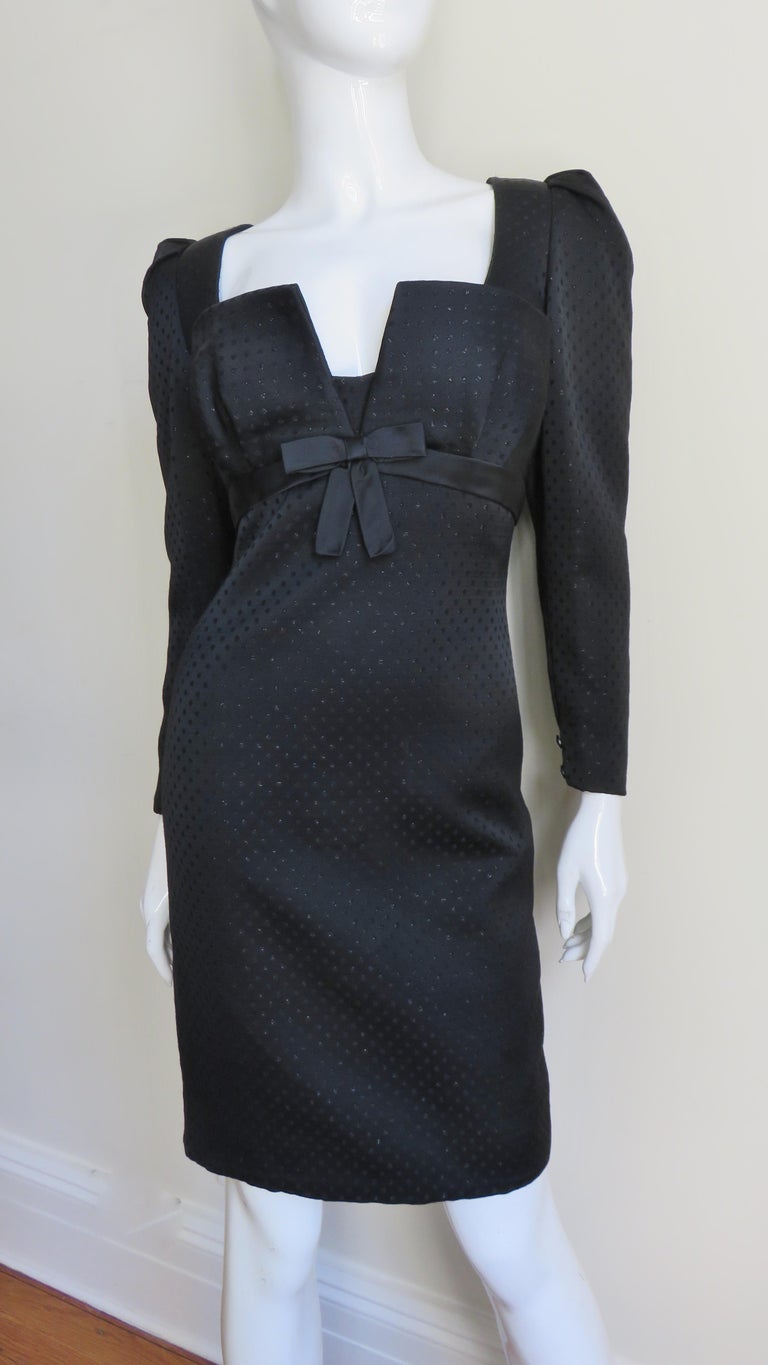 A great black silk damask dress from Renato Balestra with a subtle pattern of tiny dots throughout.  It has a square cut plunging neckline and a black band with a center front bow under the bust around the circumference of the dress.  The sleeves