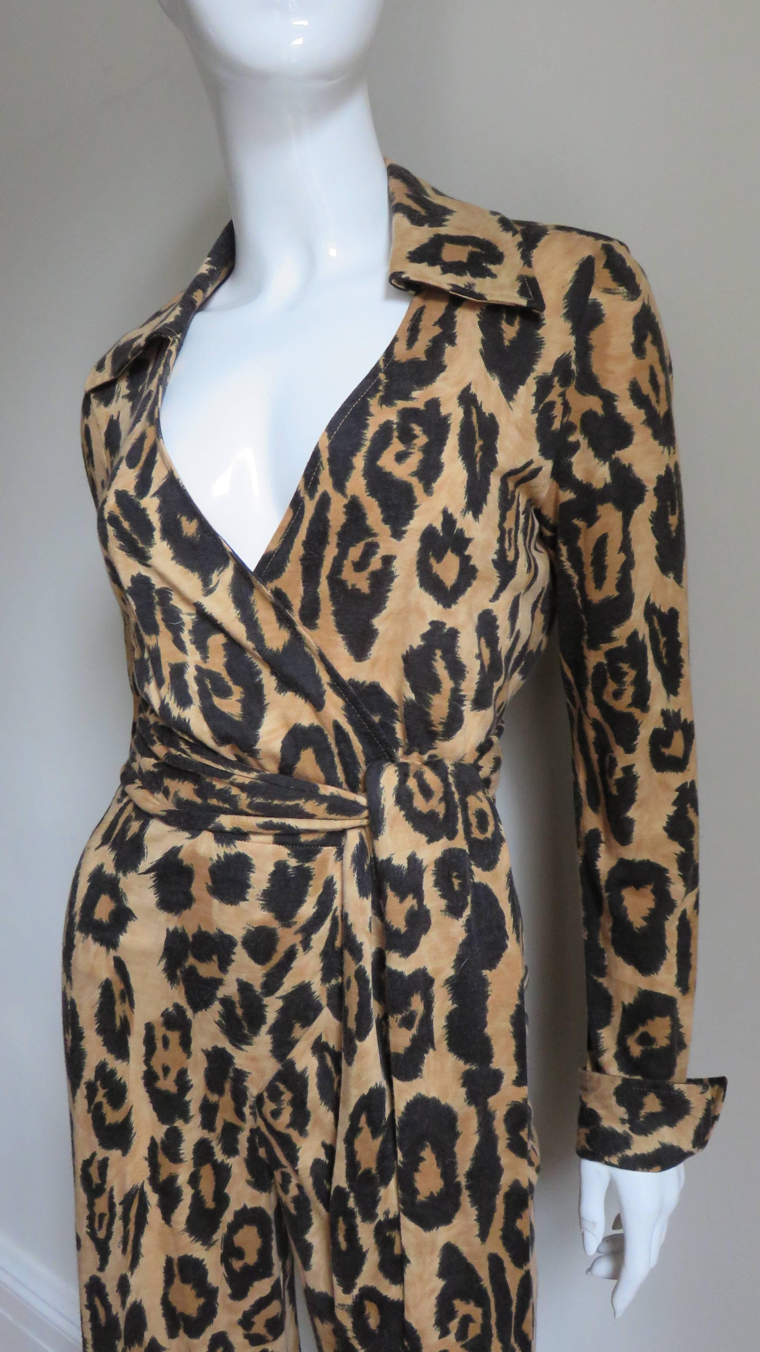A fabulous iconic leopard print silk jersey jumpsuit by Diane Von Furstenberg.  It has a shirt collar, long sleeves with fold back cuffs and it wraps tying at the waist. The legs are straight. The jumpsuit is unlined.
Fits size Small, Medium. Marked