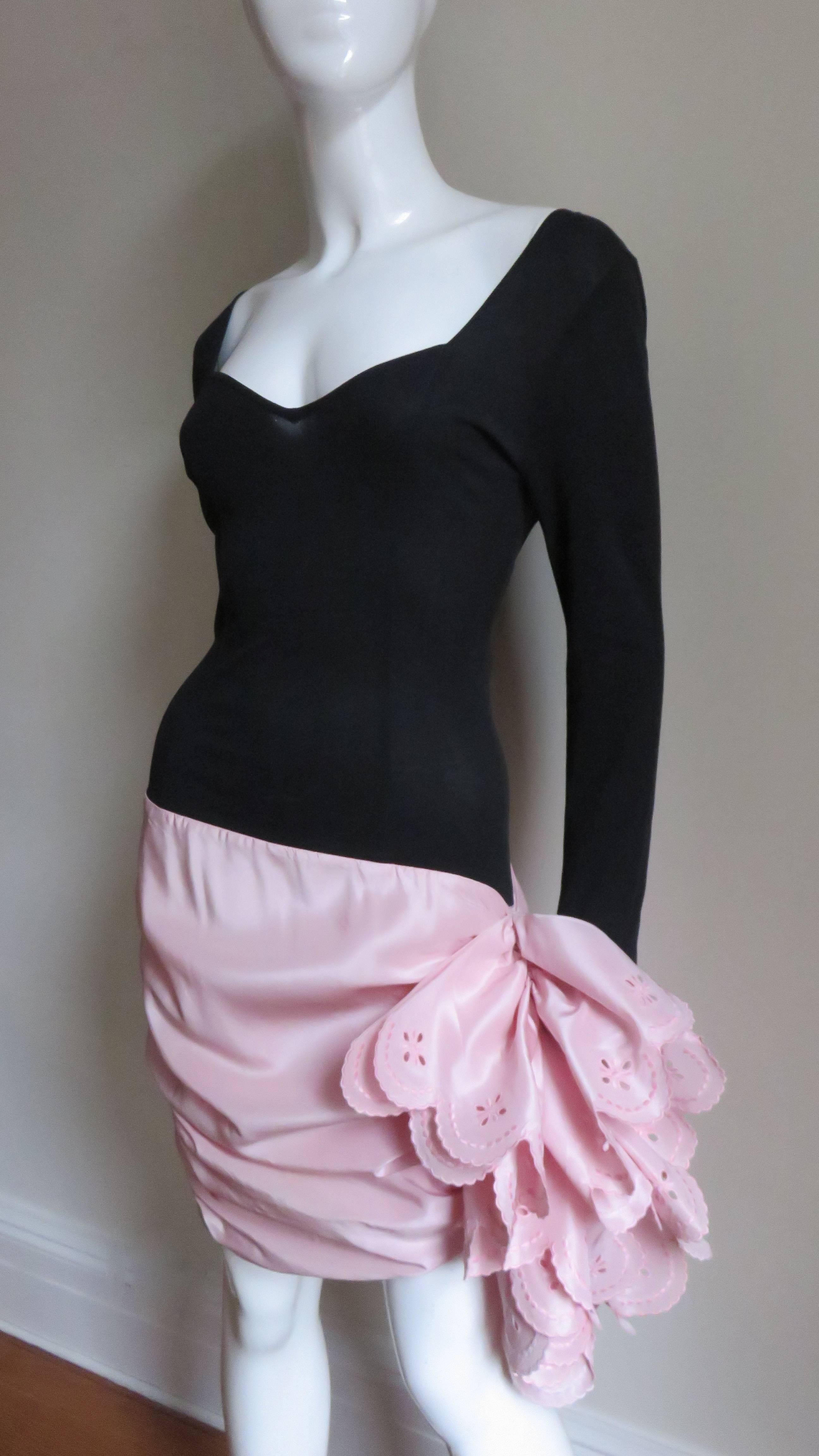 A great black jersey dress with a pink silk skirt from Angelo Tarlazzi.  It has long sleeves with a princess seaming and sweetheart neckline. The pink skirt portion has horizontal ruching  with rows of scallop edge ruffles along one side.  The skirt