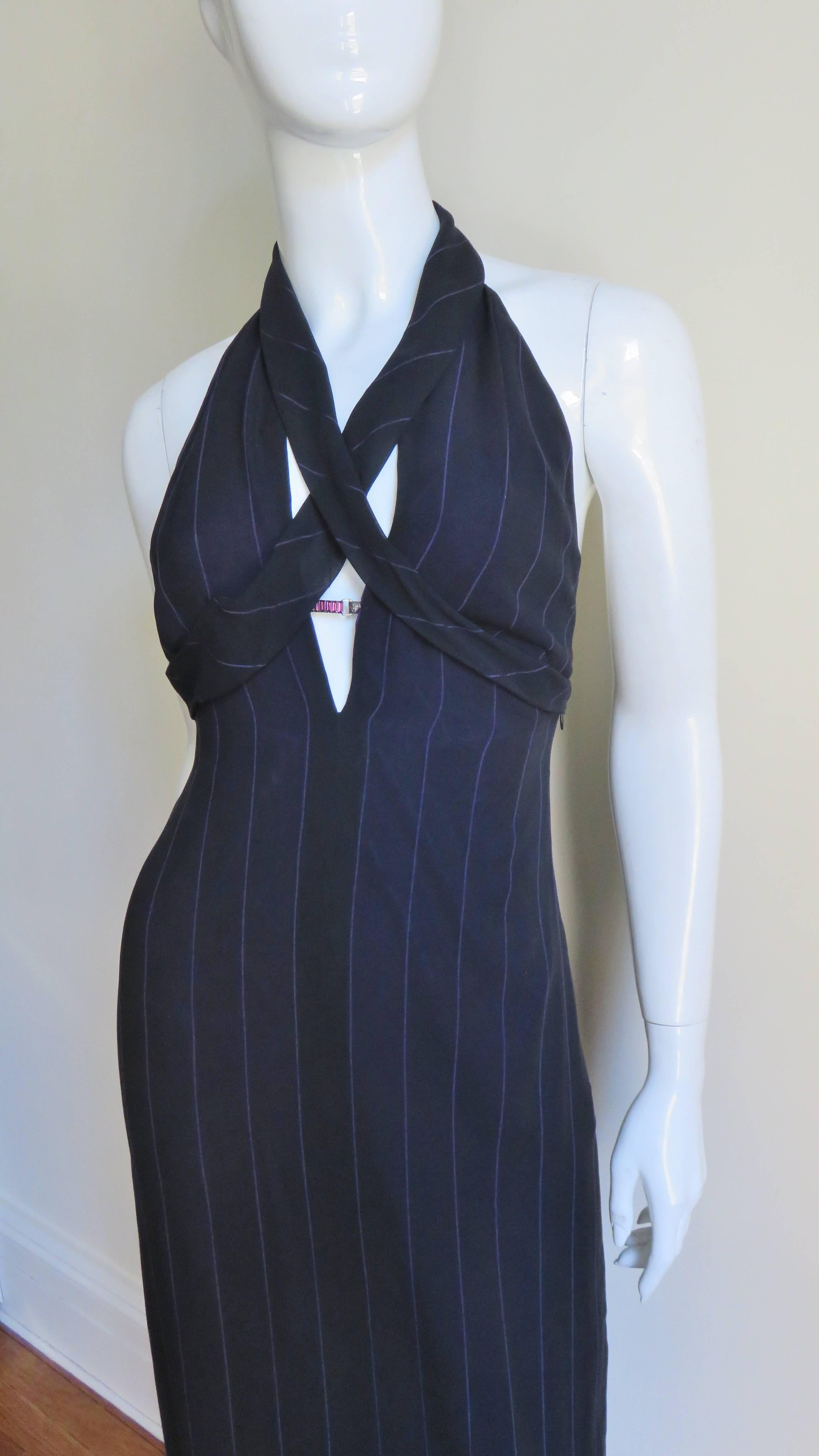 A fabulous black with fine purple pin stripes silk dress from Gianni Versace.  It has a plunging halter neckline with 2 bands of fabric crossing the chest and has a fine silver metal bar with a purple stone located mid cleavage joining the two