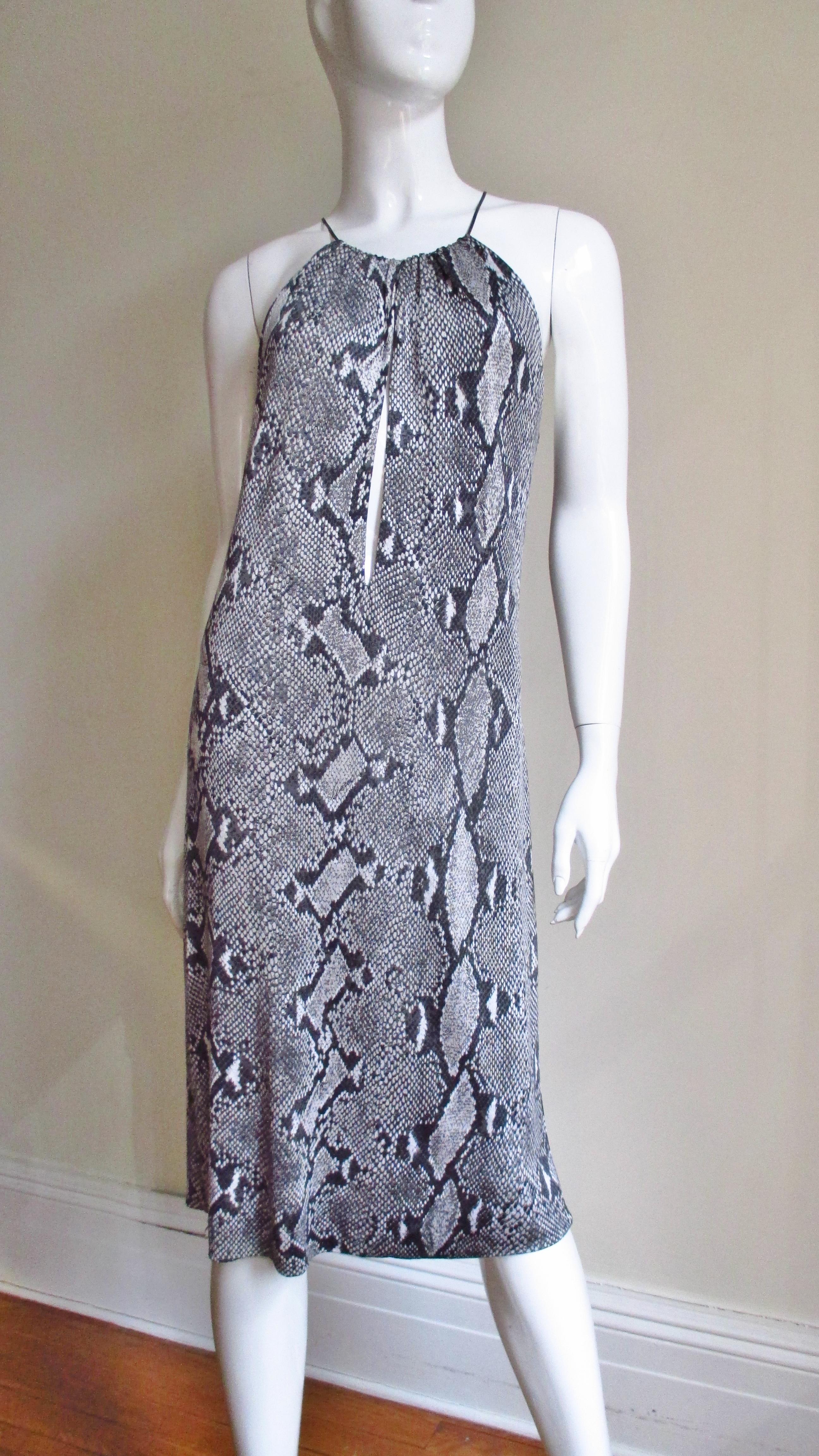 A fabulous iconic jersey dress from Tom Ford for Gucci S/S 2000 collection.  The python print in shades of grey is the highlight of the simple cut easy to wear dress.  It has a delicate leather cord at the neckline onto which the front and back of