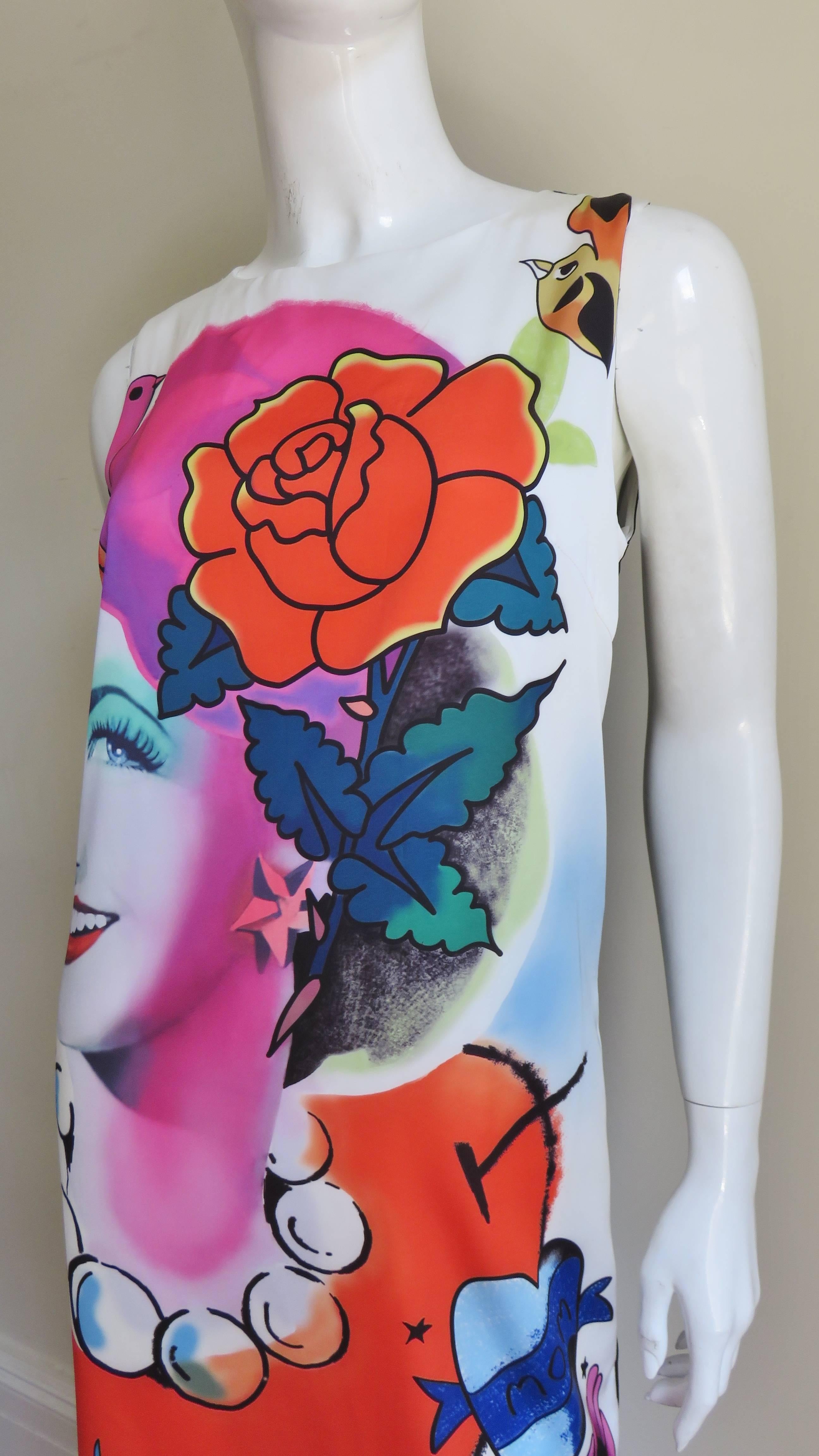 A fabulous dress with a face print from Moschino.  It is adorned on the front with a brightly colored vintage style photo print of a woman's face enhanced with flowers, birds and jewelry.  The dress is a simple sleeveless shift with a key hole back