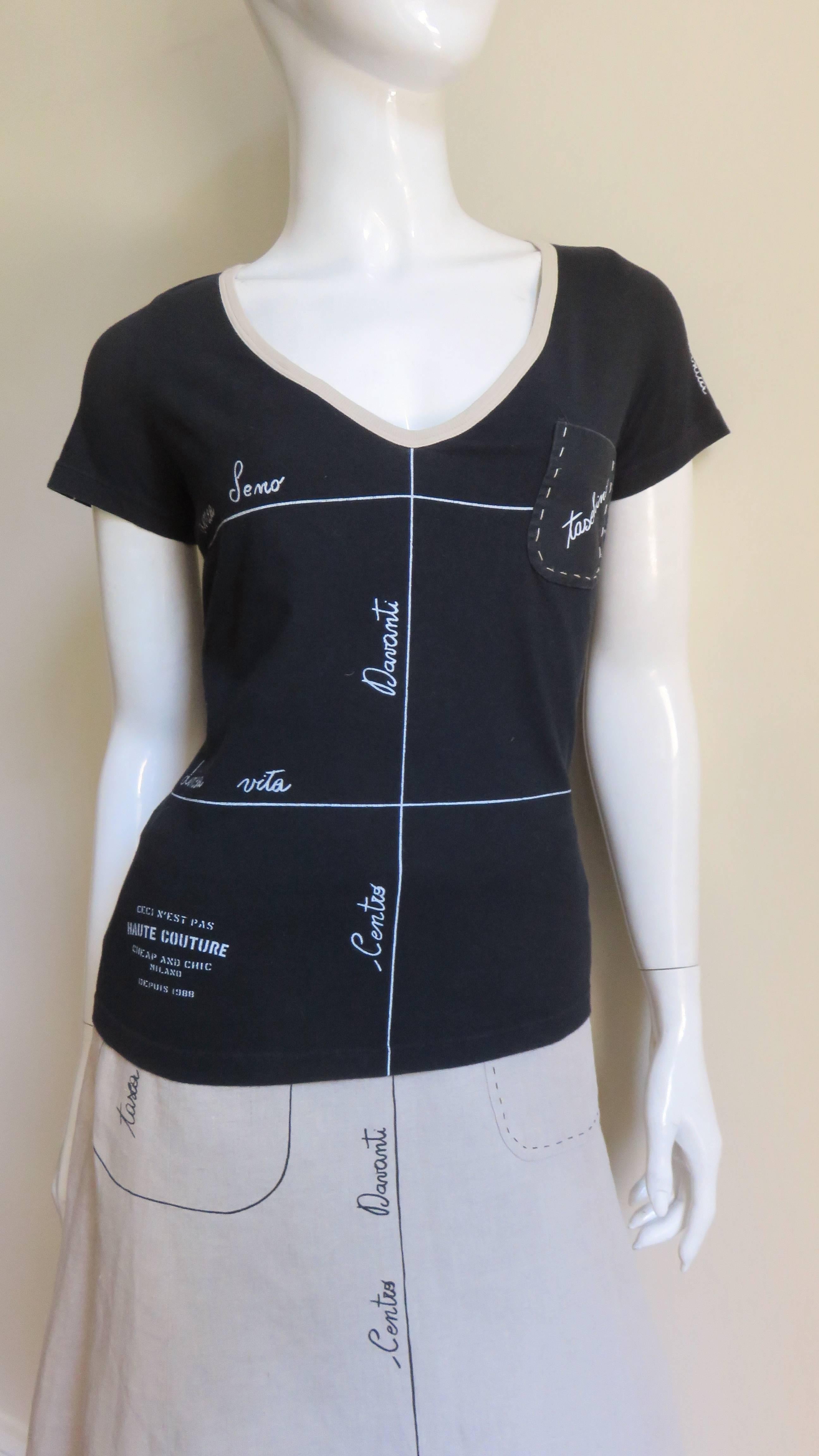 A great 2 piece set from Moschino in black cotton and beige linen.  The t shirt has a V beige bound neckline, short sleeves and a hand stitched breast pocket.  There are white lines and Italian words depicting design and construction features on the