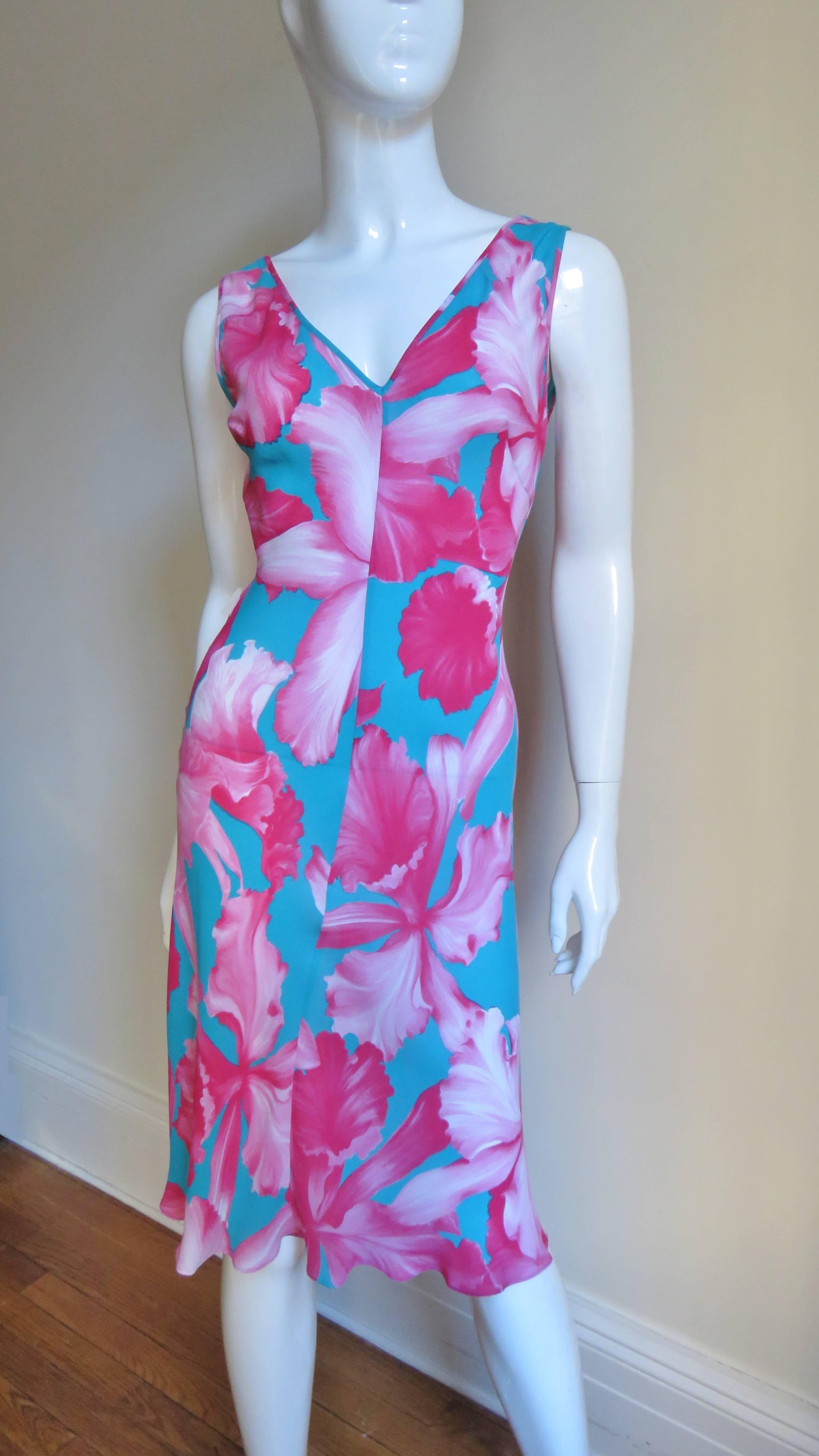 A gorgeous pink and turquoise tropical flower print silk dress with a matching silk fringe wrap/tie belt from Celine.  It is sleeveless with a V front and deeper V back, semi fitted through the waist then flares to the hem and comes with a pink silk