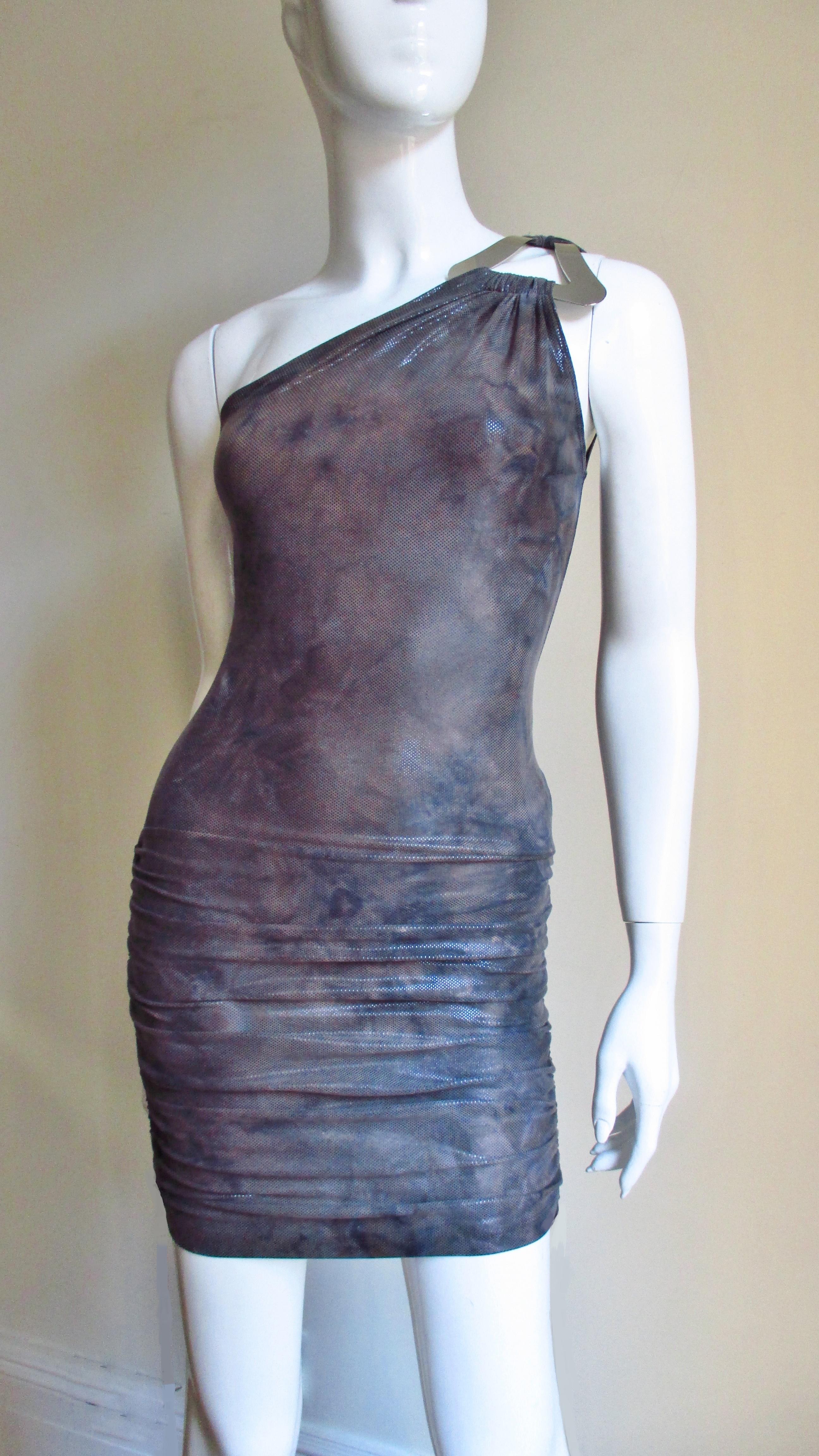 A muted grey and brown synthetic blend knit dress from Gianni Versace Couture with a large silver hardware triangle at the shoulder holding the front and back straps.  It is bare on the other shoulder, fitted through to the hips where it has side
