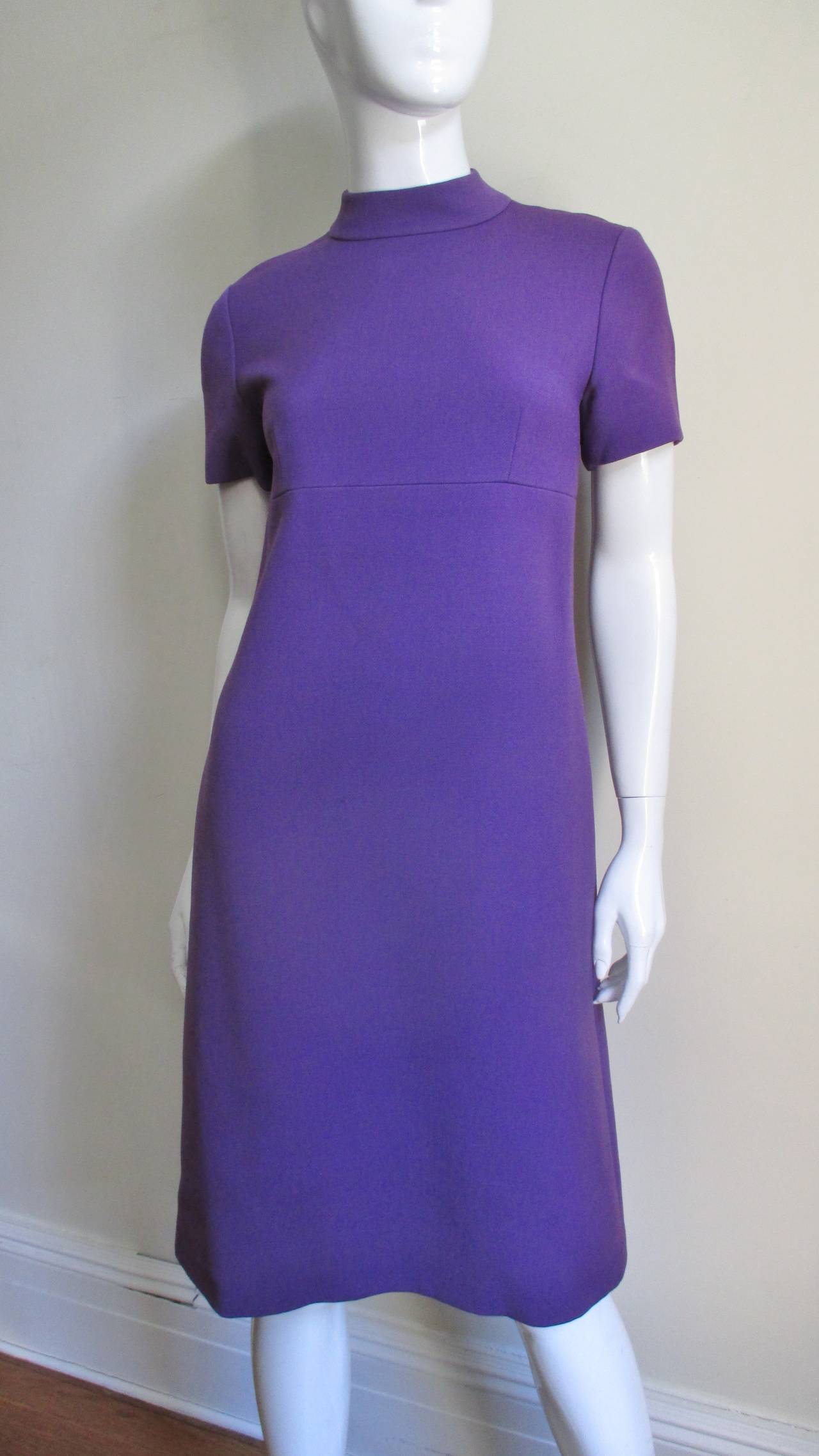 An amazing purple wool dress and coat set from Yves St Laurent YSL for Christian Dior.  The dress is a simple short sleeved shift with a stand up collar, and a back hand stitched zipper.  The double breasted coat has 4 matching buttons and bound
