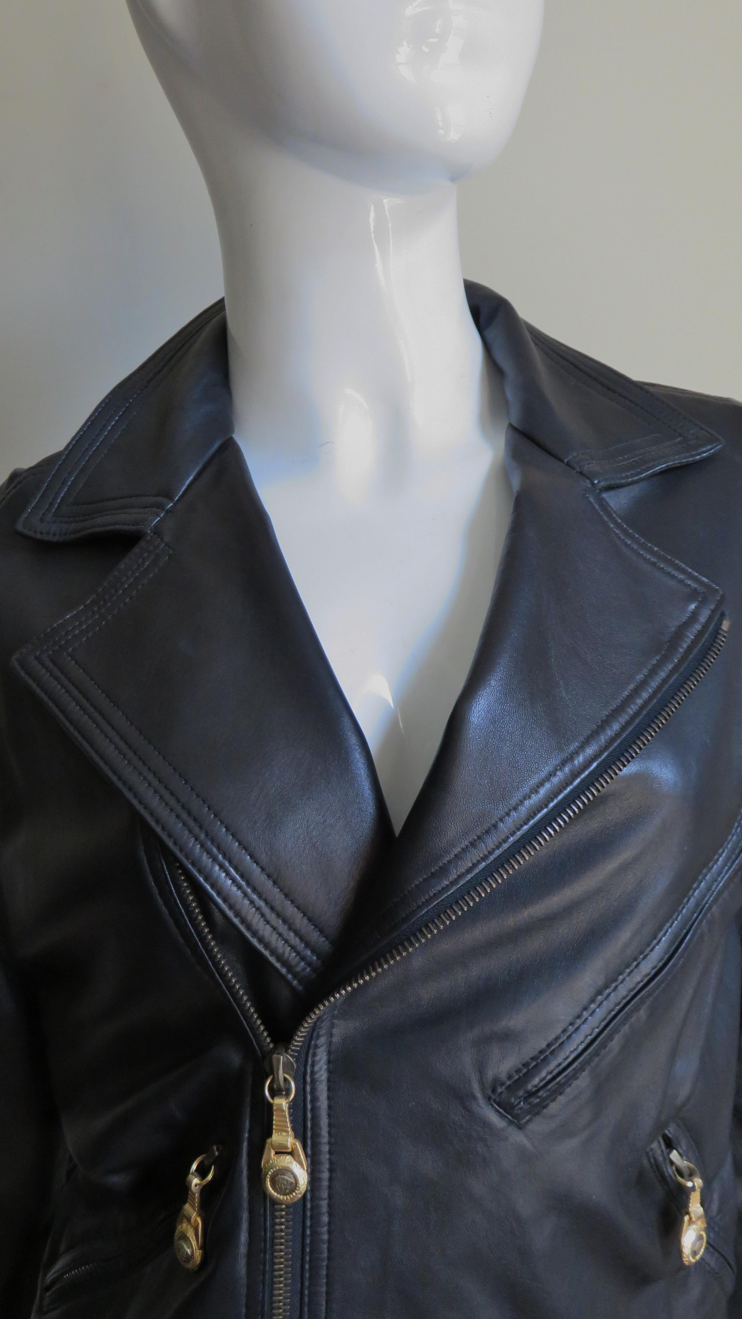A fabulous black soft leather motorcycle jacket from Gianni Versace.  It has a front zipper, a lapel collar that can be zipped closed, zipper cuffs, a functional front belt with a metal buckle and 3 zipper front pockets with metal Medusa head