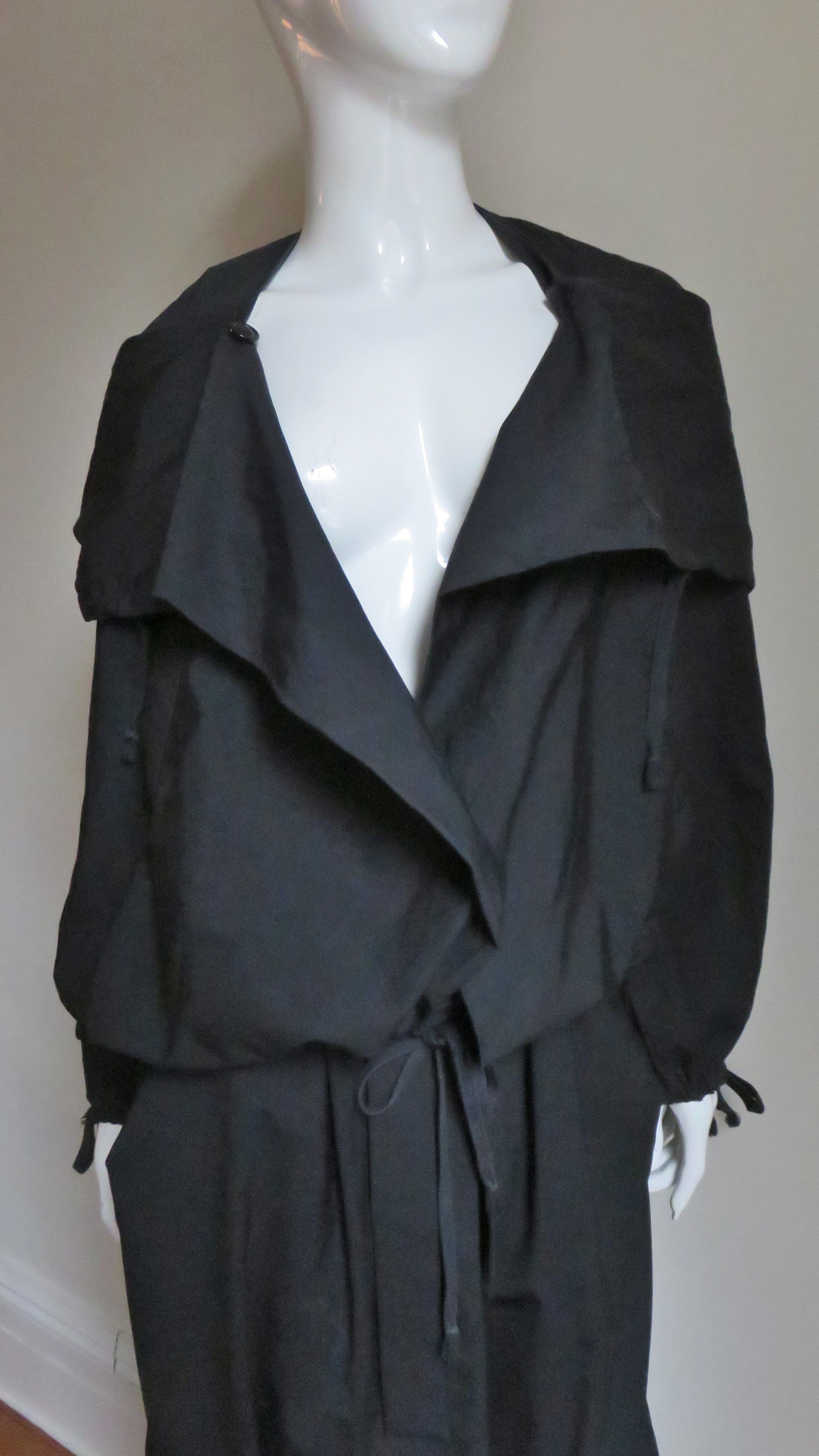 This is a fabulous set from in a black wool cotton blend from Vivienne Westwood.  It consists of drop crotch harem style pants gathering onto a waistband. There is draping on the front and along the legs and side seam pockets.  The jacket has