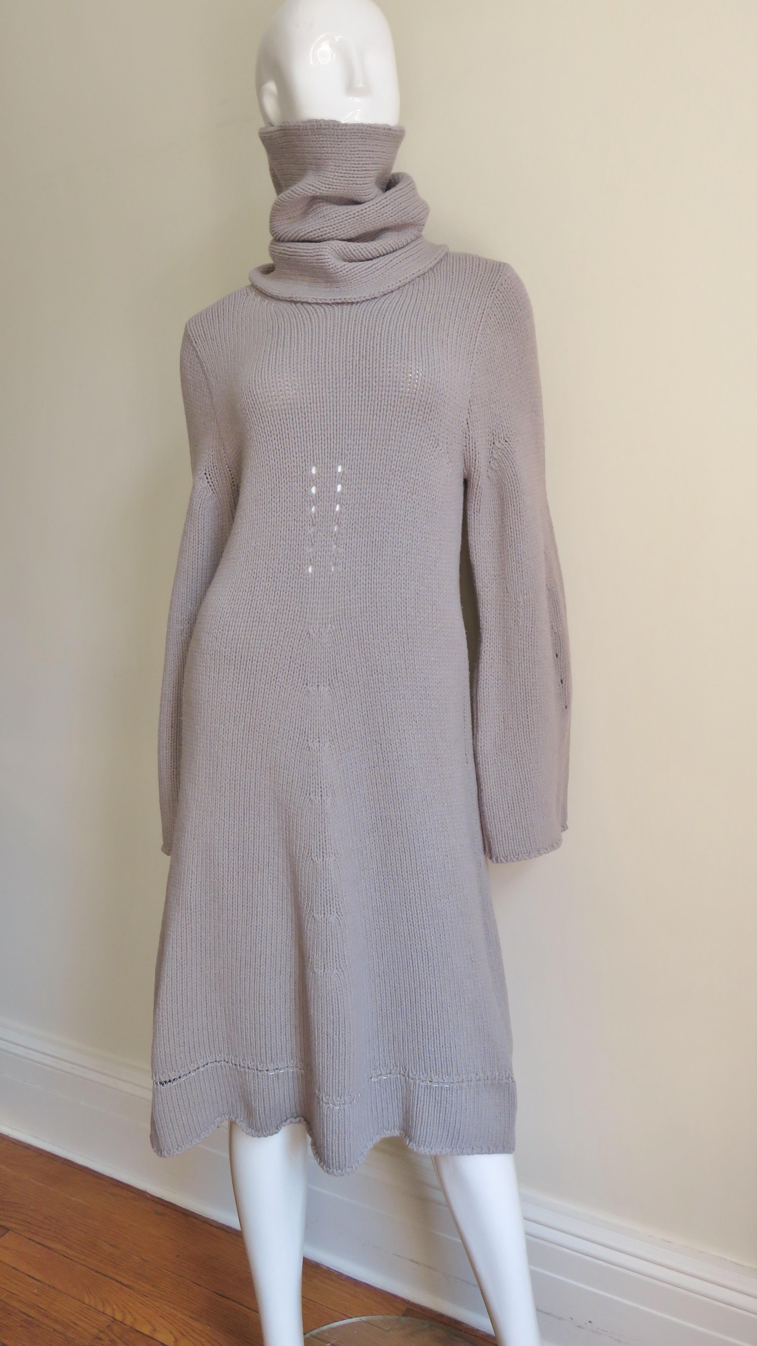 A fabulous taupe wool knit over sized sweater dress and separate turtleneck from Belgium designer Ann Demeulemeester.  The dress follows the line of the body then flares to the hem. It has long sleeves and comes with a separate neck tube.
Fits sizes