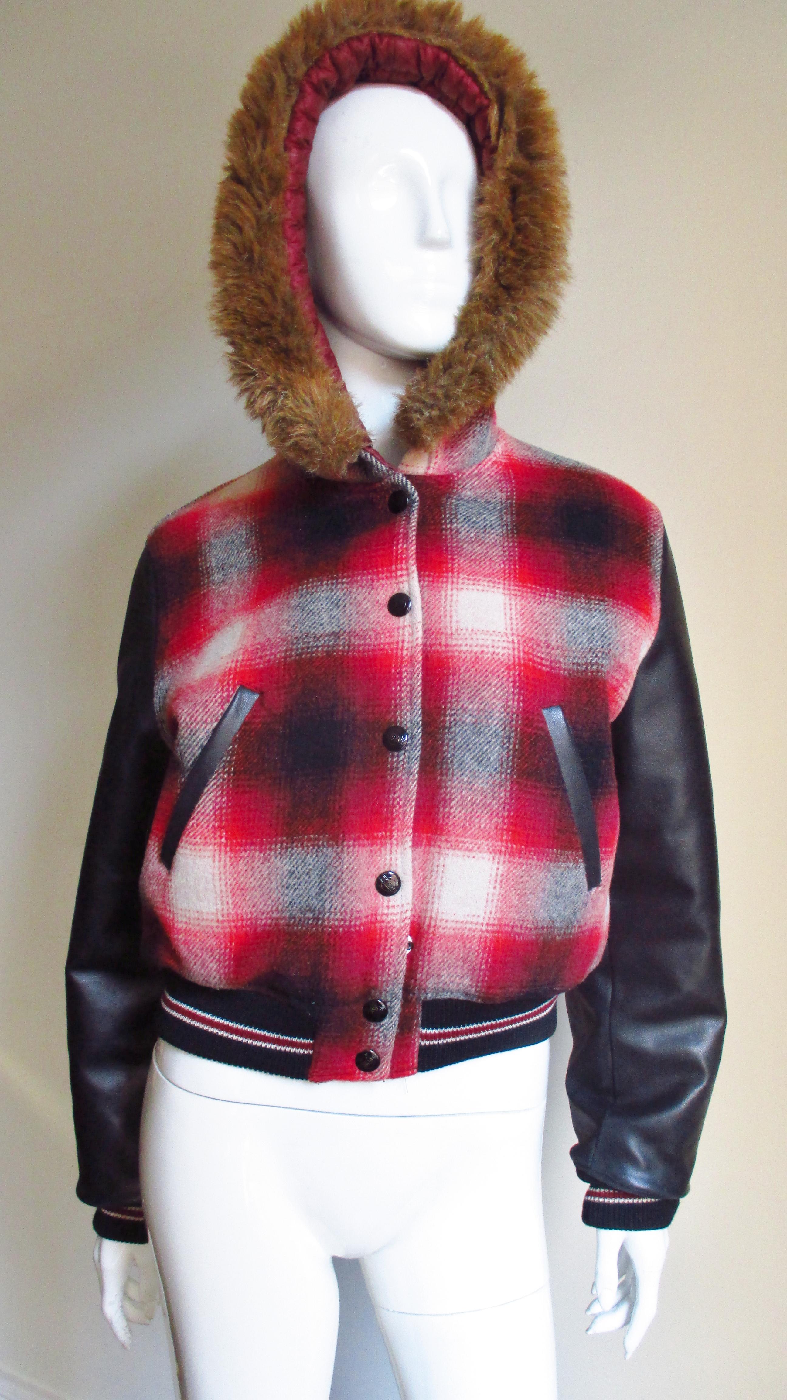 A great watch plaid red white and grey wool jacket with pleather sleeves and faux fur trim from Jean Paul  Gaultier's Junior Gaultier.  It is a bomber style jacket with long black faux leather sleeves and stripped 2