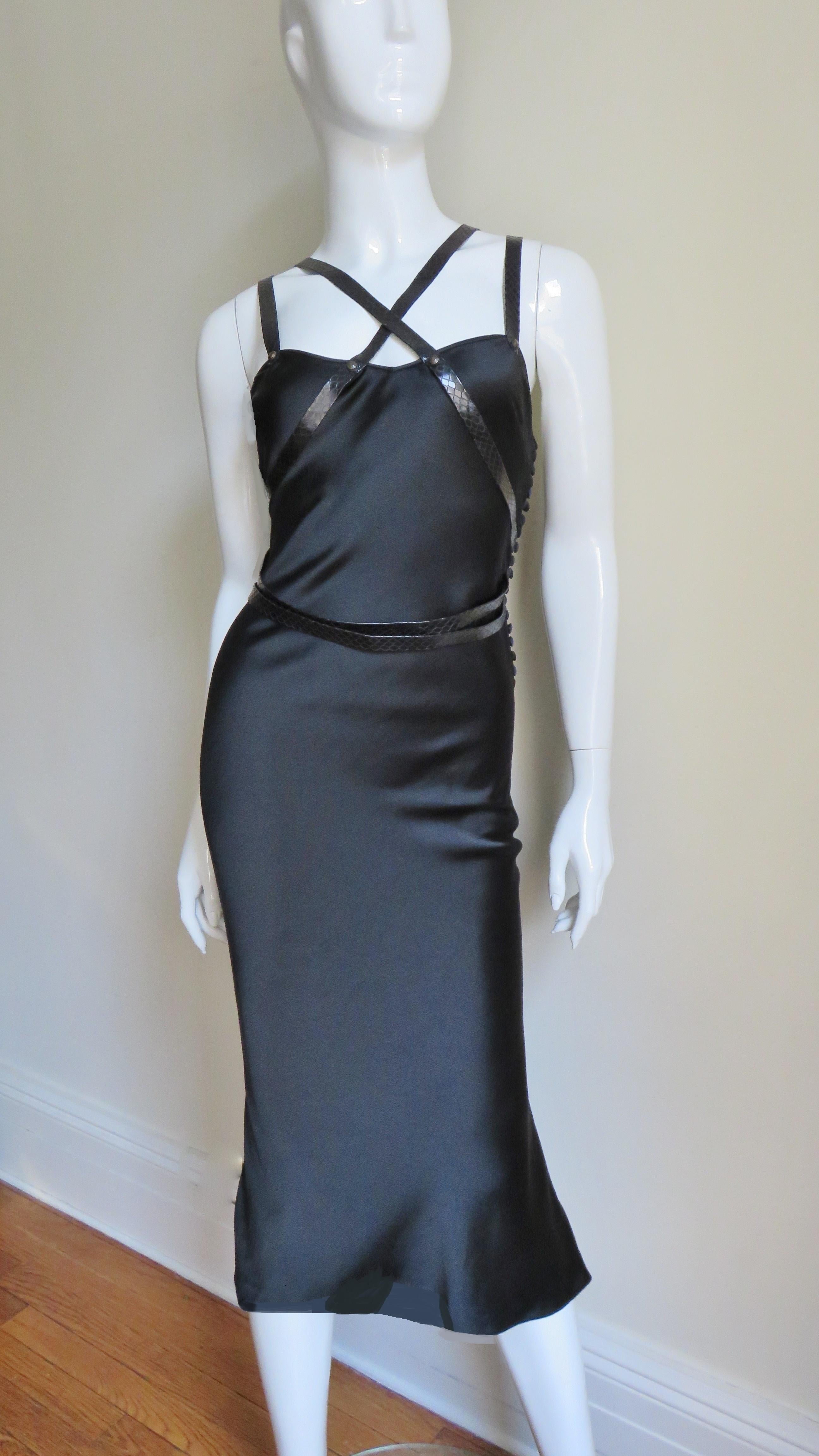 A fabulous black silk dress from Christian Dior. It is a fitted slip style dress adorned with 1/2