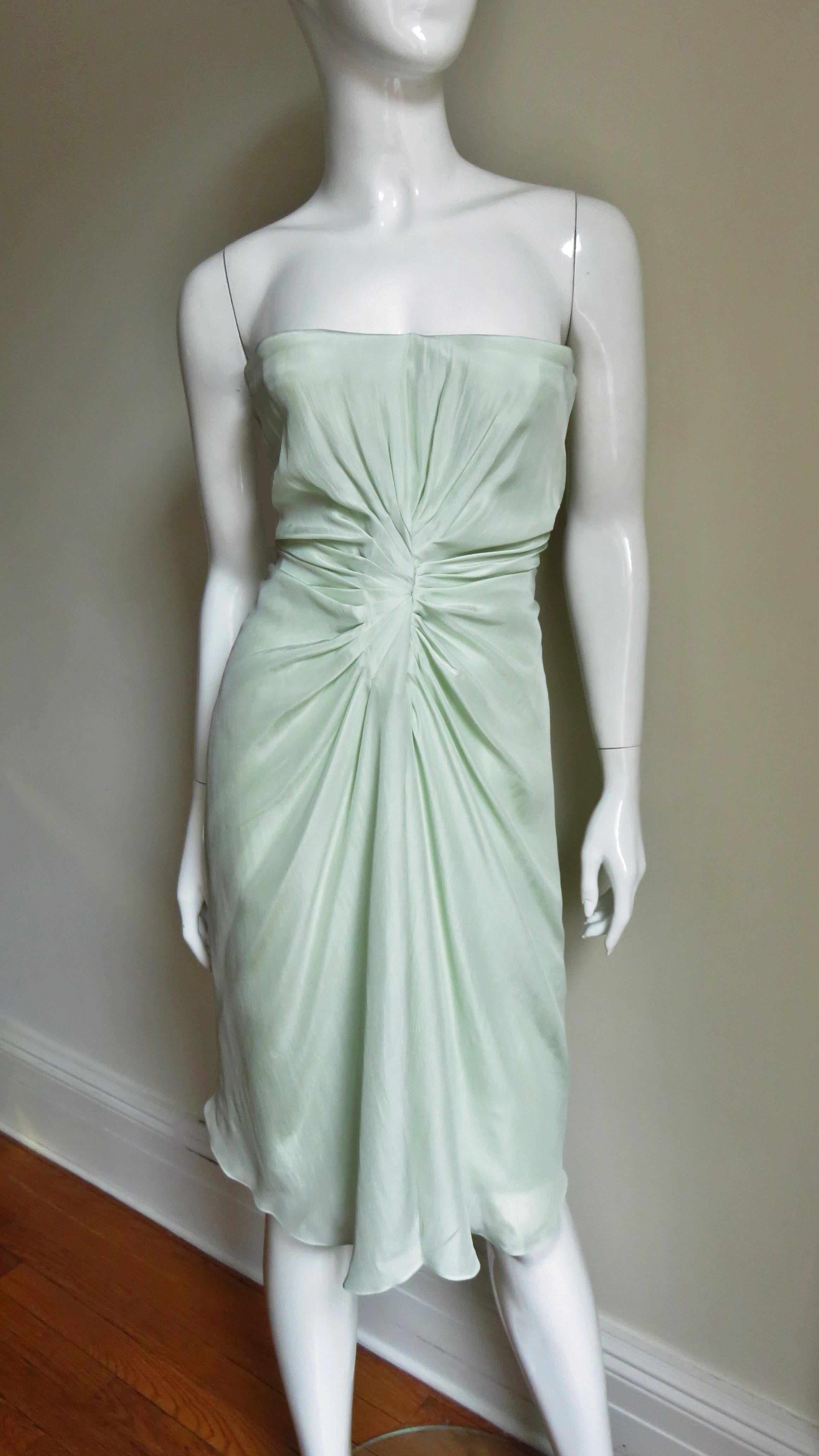 A gorgeous light mint green silk dress by john Galliano for Christian Dior. It has an underwire inner boned corset with detachable adjustable straps so it can be worn strapless if desired.  Very flattering with an array of seaming and tucks on each
