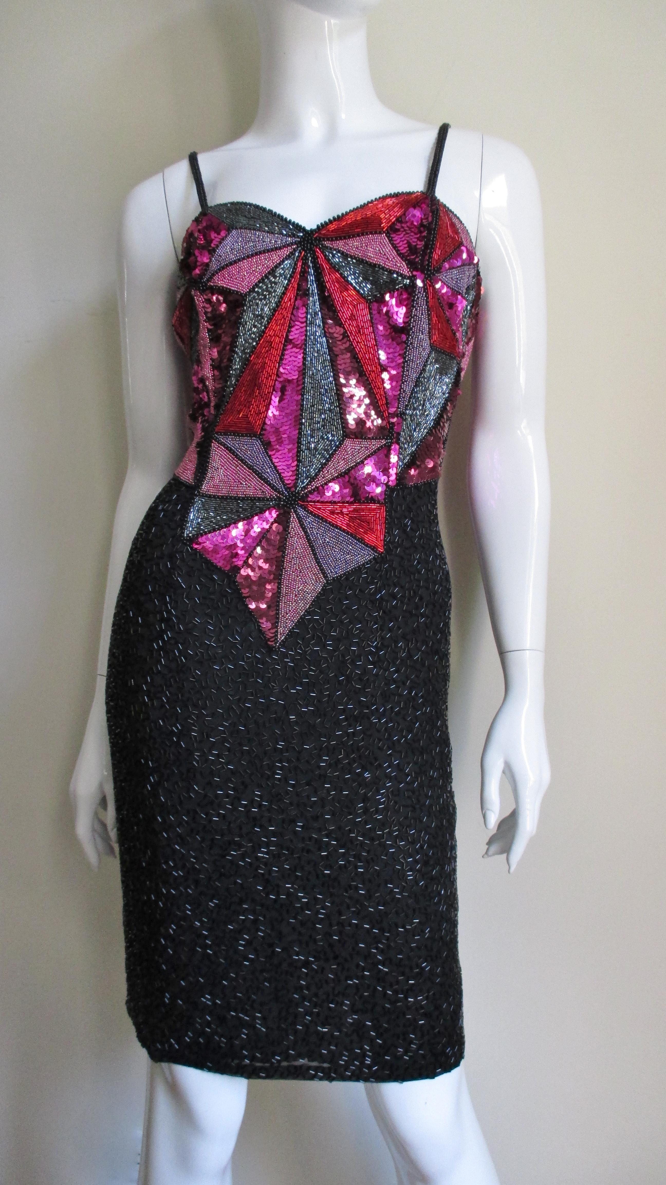 A beautiful black silk cocktail dress from Christian Lacroix with elaborate beading and sequins in magenta, rose, silver and red. The pointed bodice has beaded spaghetti straps and is comprised of an intricate pattern of lines and angles filled with