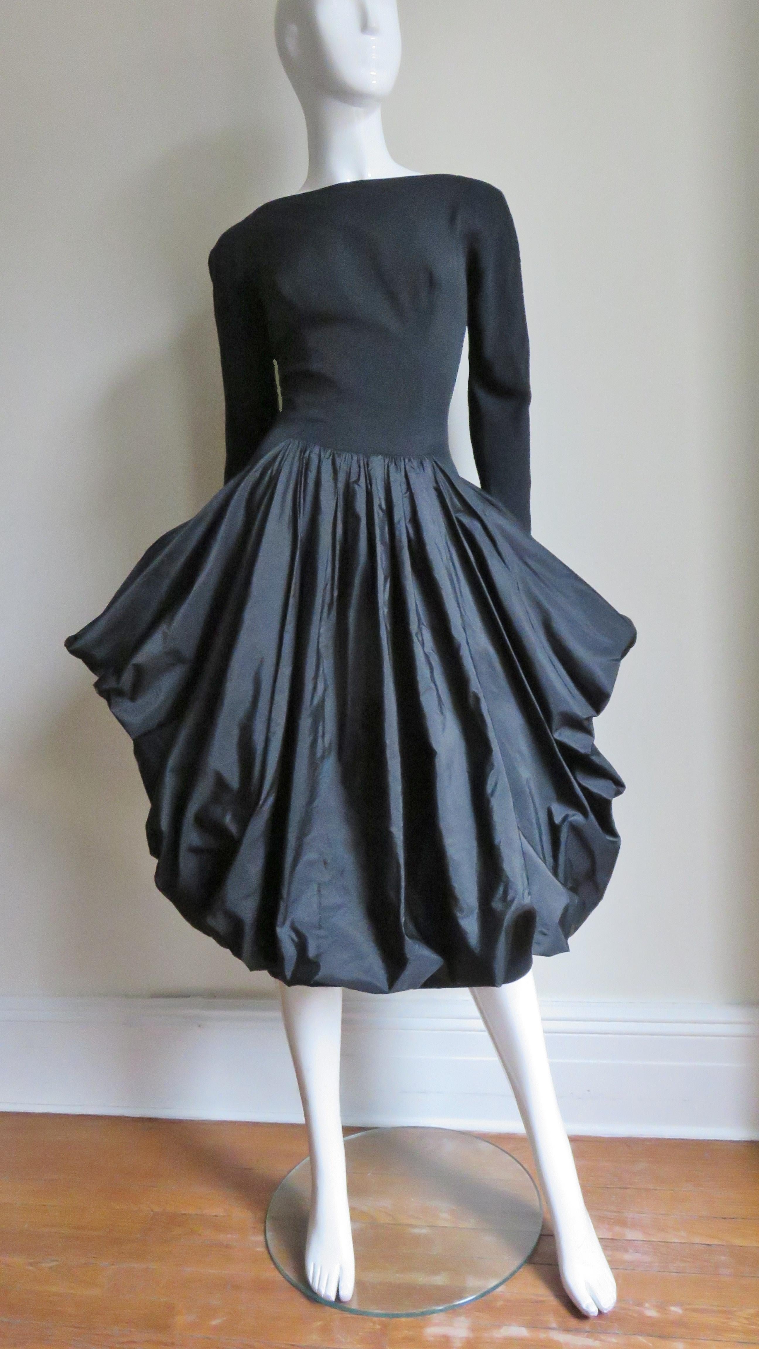 A gorgeous black silk dress from Marberl.  It has long sleeves with fine metal zippers at the wrists, a princess seamed bodice for a great fit and a deep V cut back.  The sleeves are cut in one piece with the bodice front and back creating a