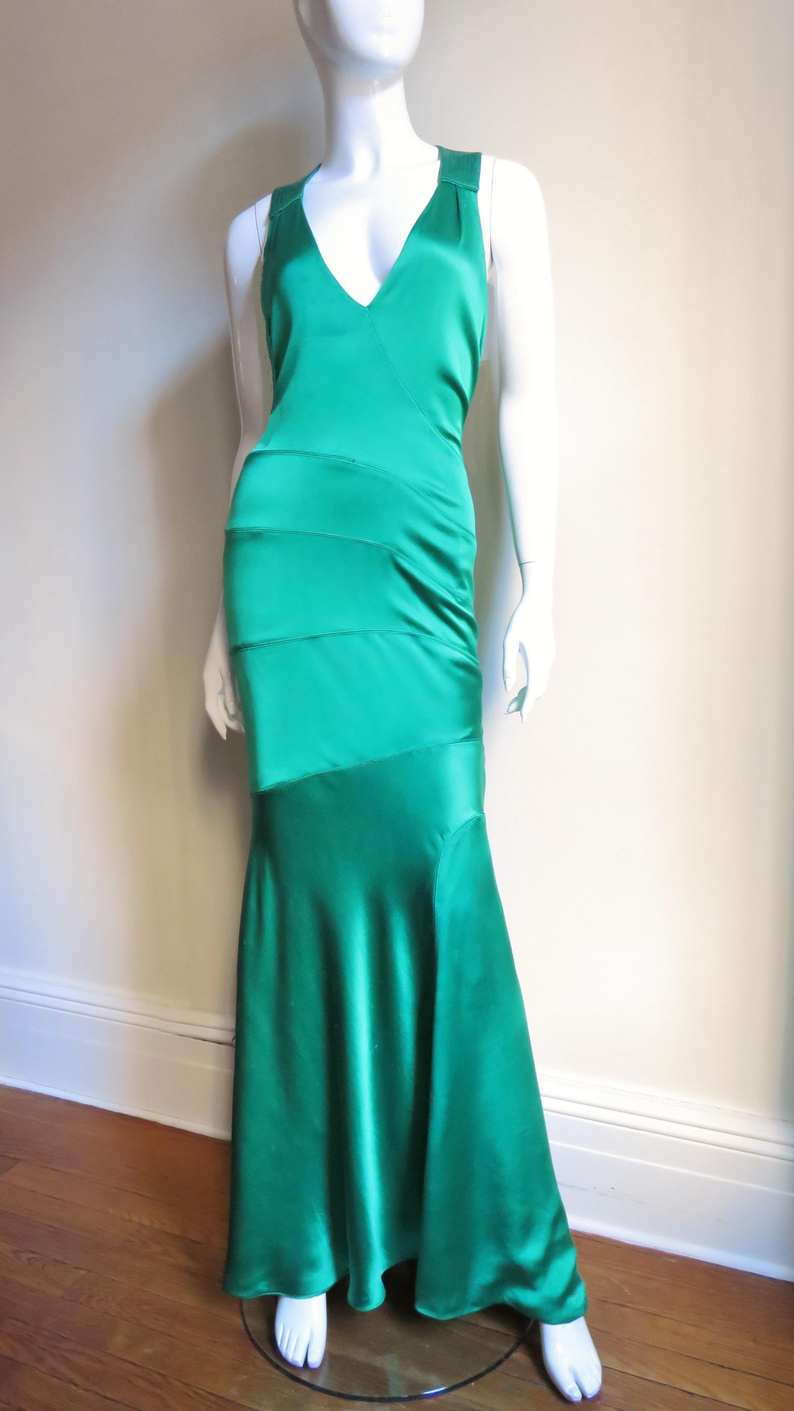 This is stunning- a gorgeous emerald green silk charmeuse gown from Gianni Versace Couture created in the glamorous style reminiscent of Hollywood days gone by.  It is fitted through the body with seaming in angles across the front, has a plunging